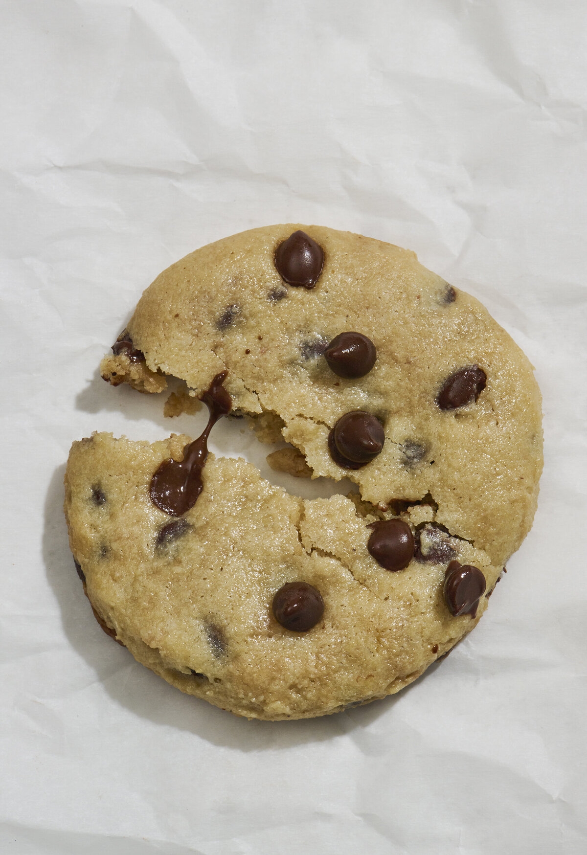 a melty chocolate chip cookie on paper