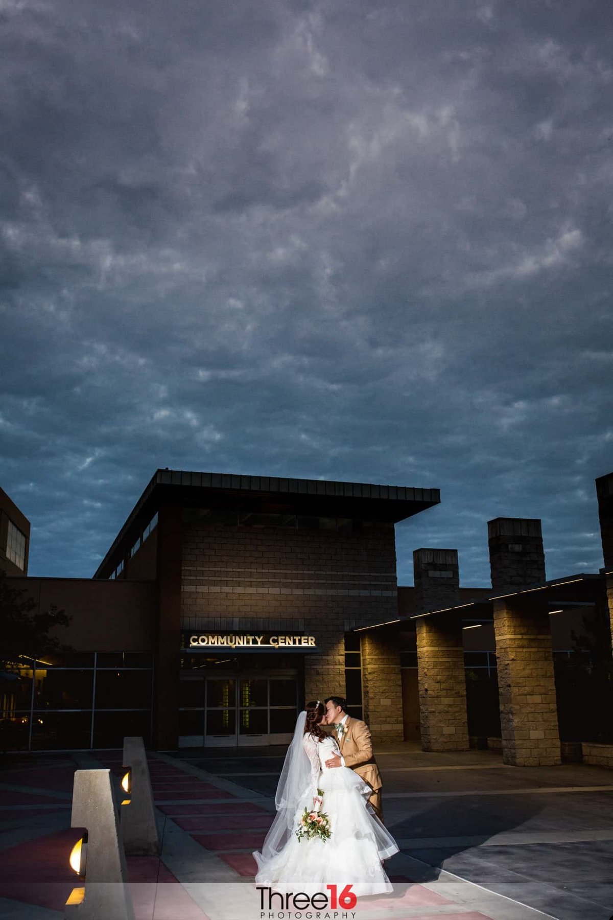 Bride and Groom share a kiss in front of the Brea Community Center