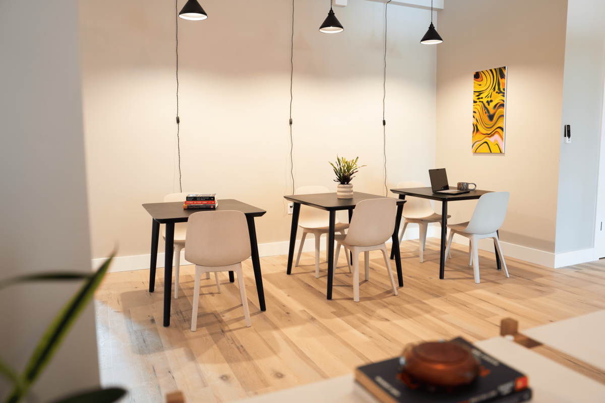 Brooklyn coworking space with cozy lighting, local artwork and tables and chairs.