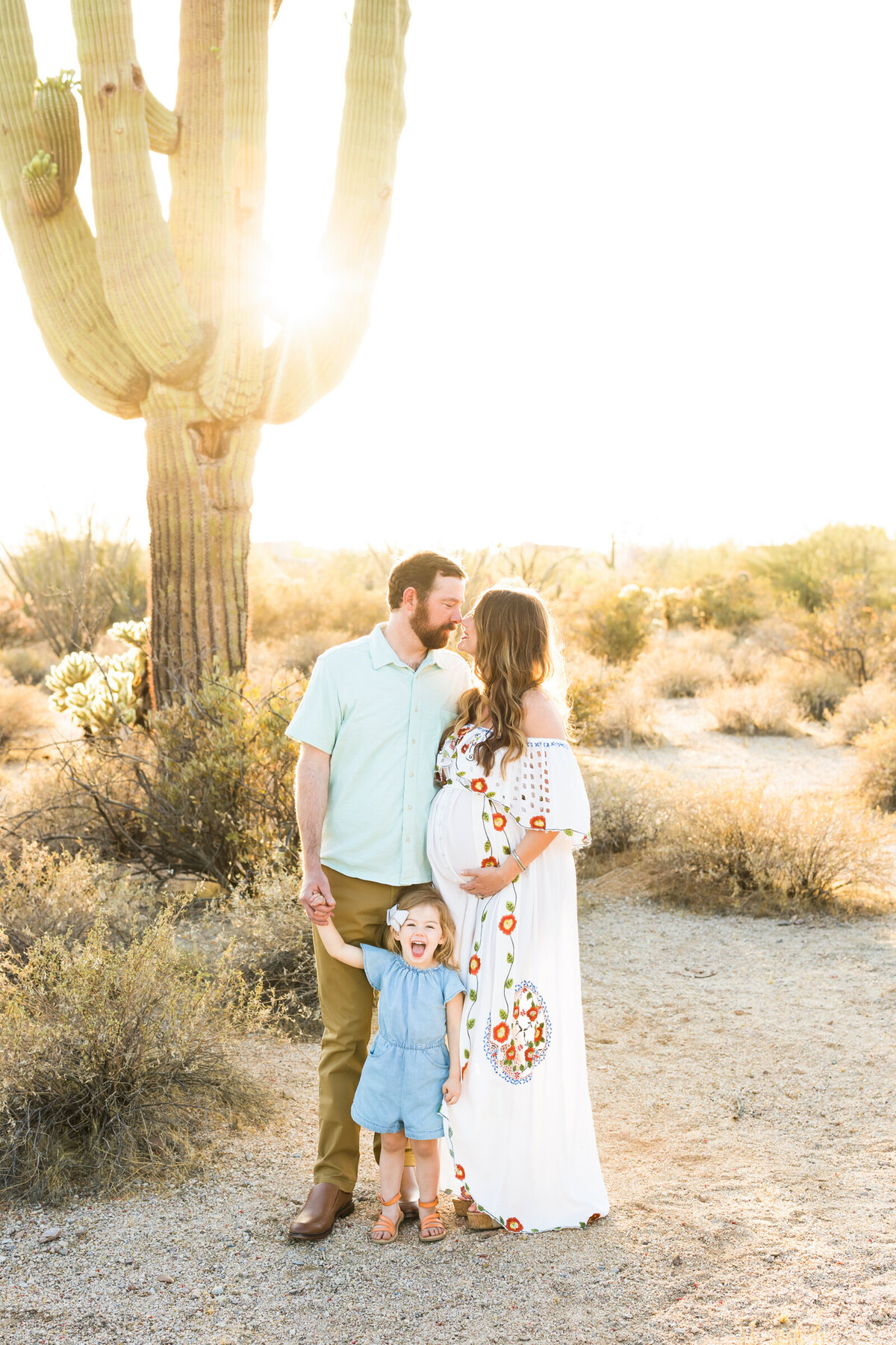 family posing together for maternity photo