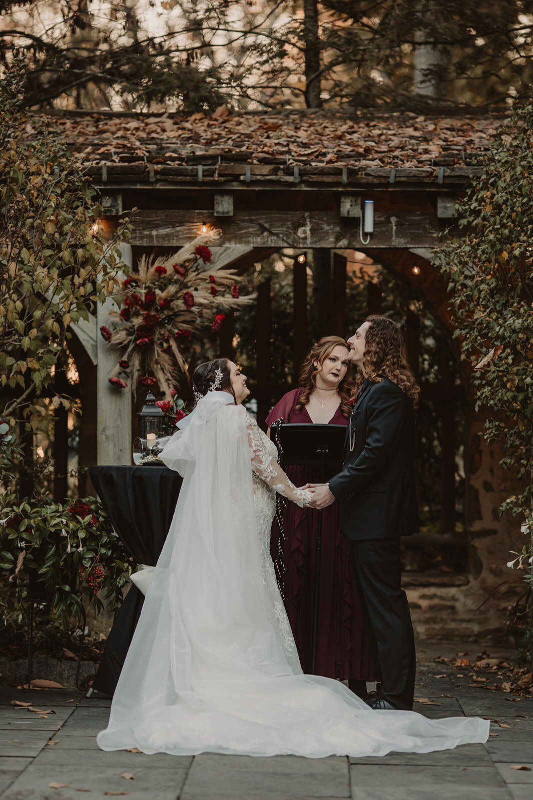 A couple holding hands during their wedding ceremony 