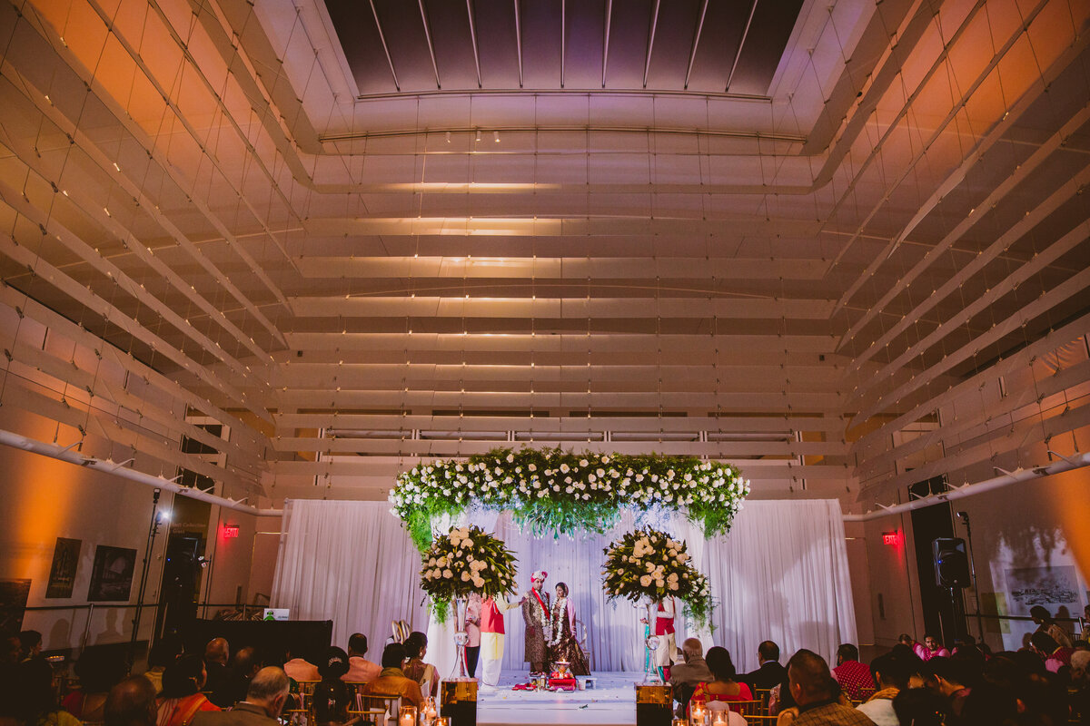 wide photo of a hindu indian wedding ceremony at the queens museum in ny