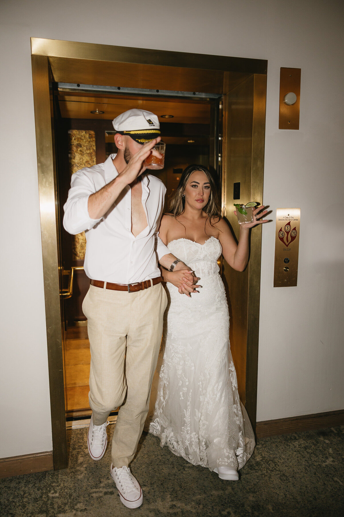 Bride and groom exiting elevator at Hilton Beachfront Resort Santa Barbara