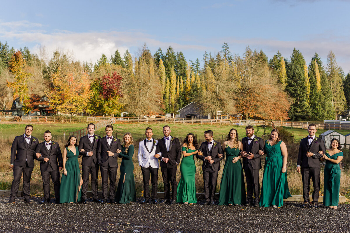 Fun-wedding-party-link-arms-for-photos-at-LGBTQ-wedding-at-Liljebeck-Farms-in-Woodinville-by-Joanna-Monger-Photography