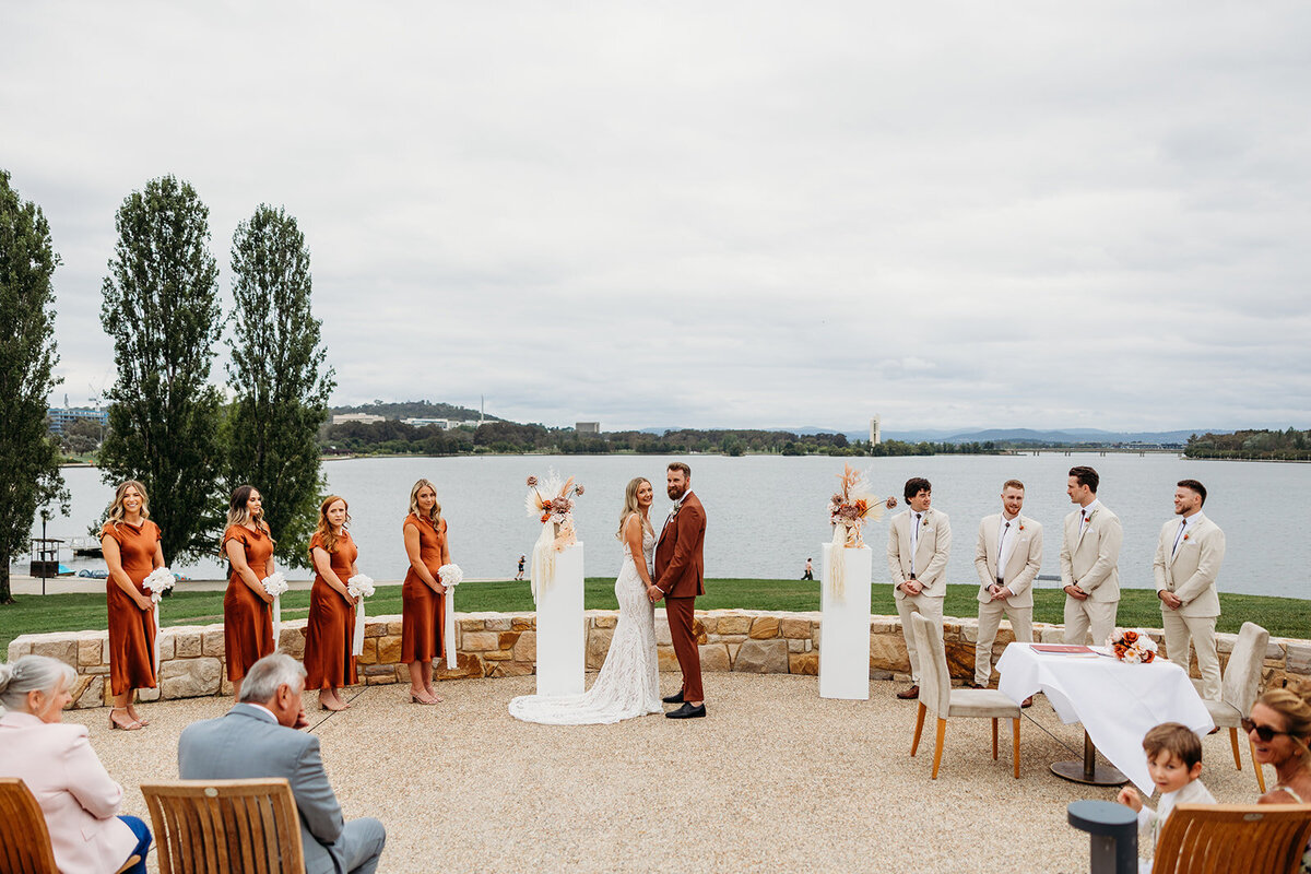 Wedding ceremony at the Marion overlooking Lake Burley Griffin on a cloudy day in Canberra ACT
