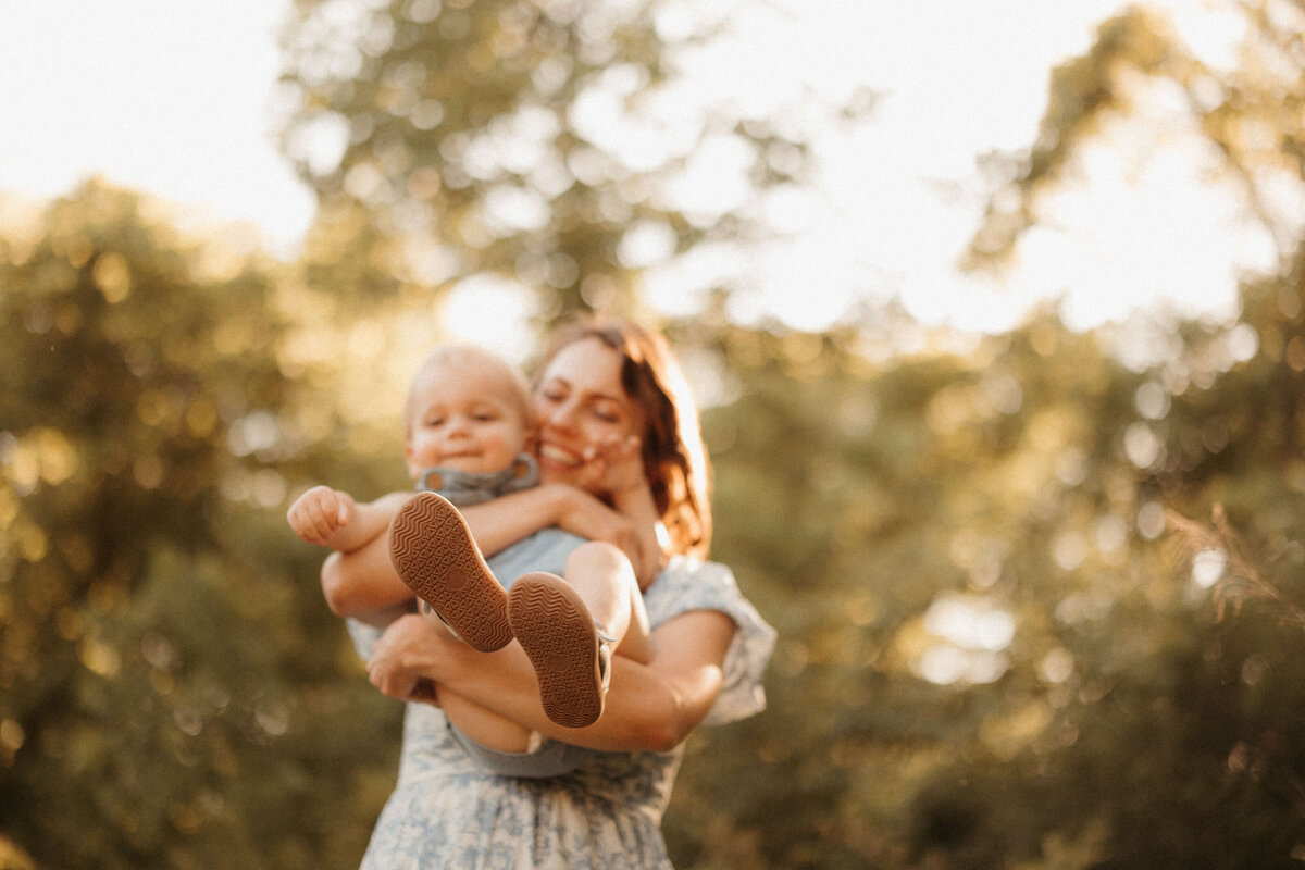  Parents swinging child by the arms during Nashville Tennessee park family session