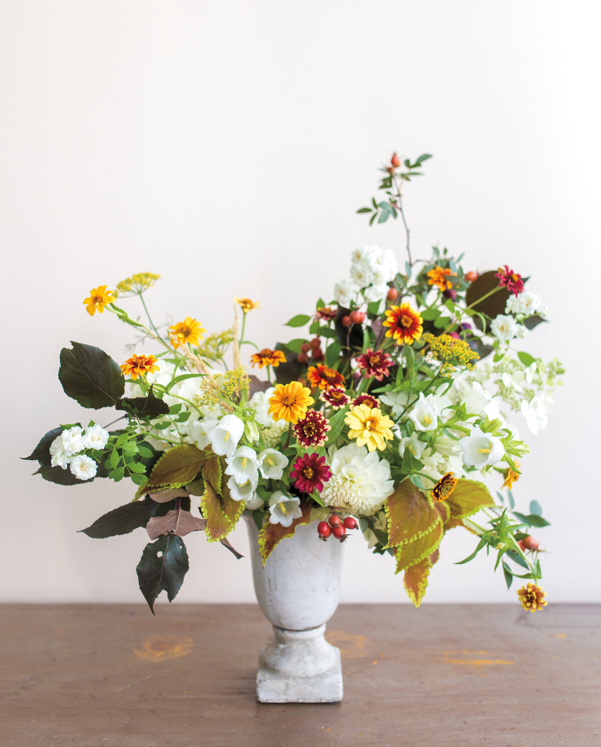 Red, orange, and white flowers in a ceremony arrangement for a Montreal wedding.
