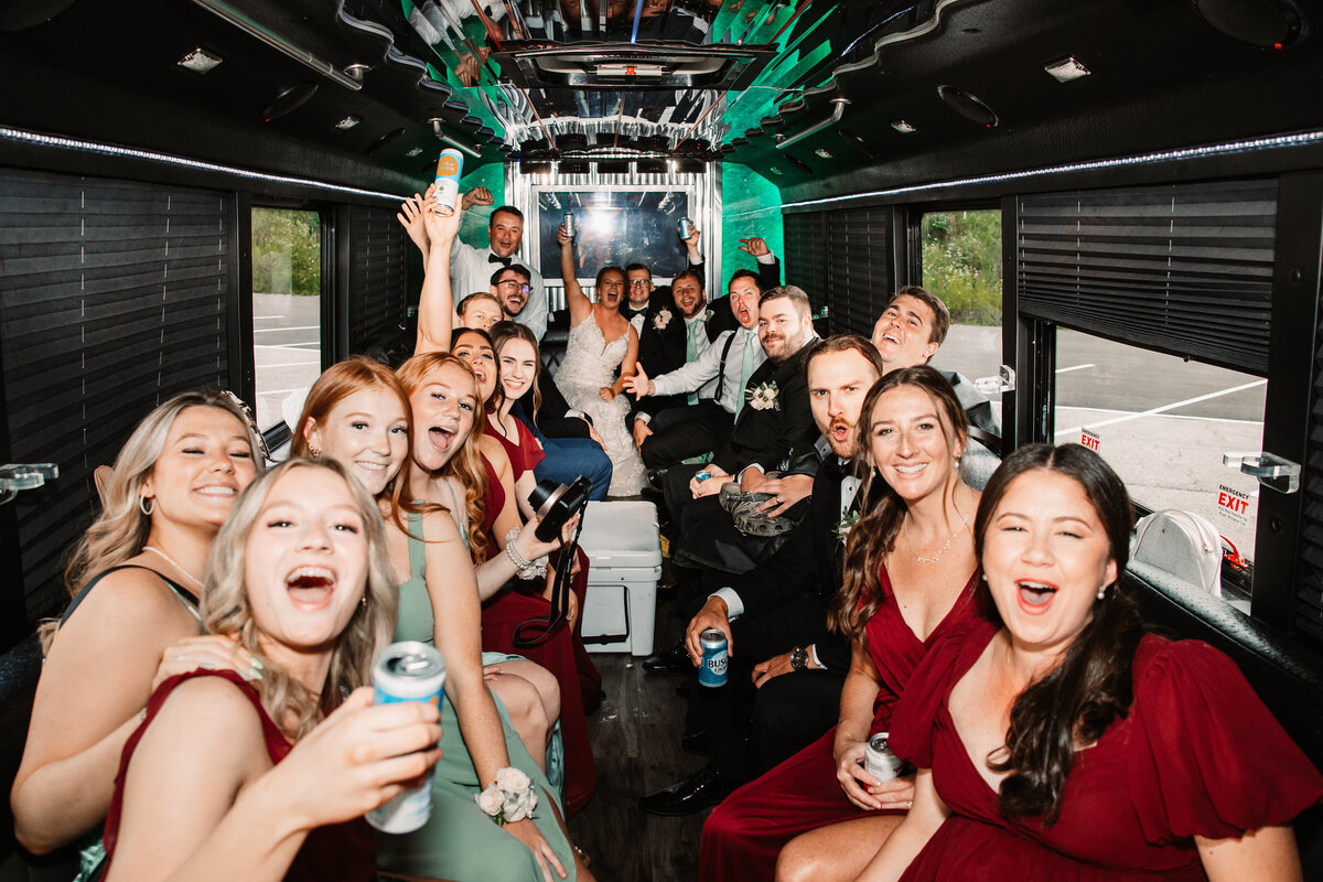 Newlyweds celebrate in a party bus with their bridal party