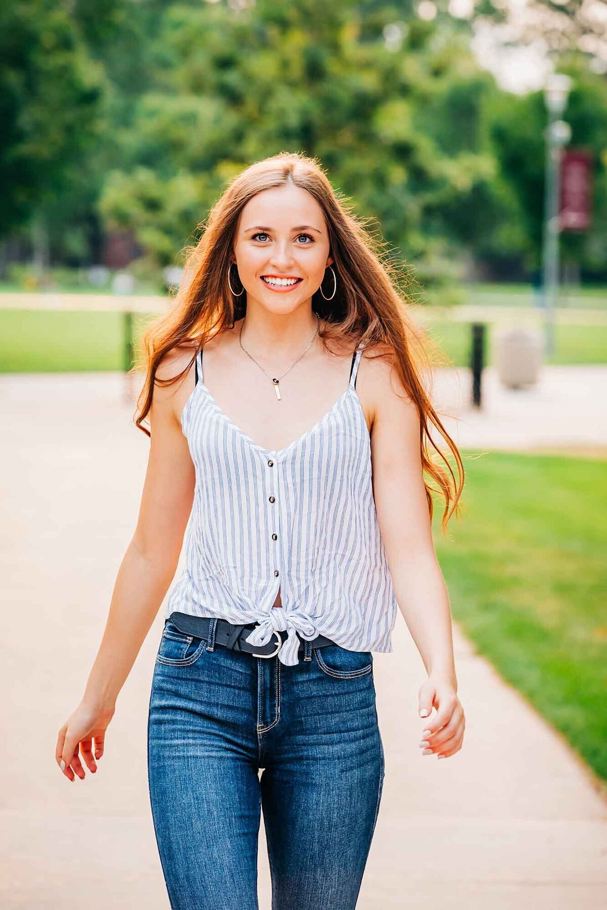 Senior photo of girl walking on University of Montana campus, Missoula