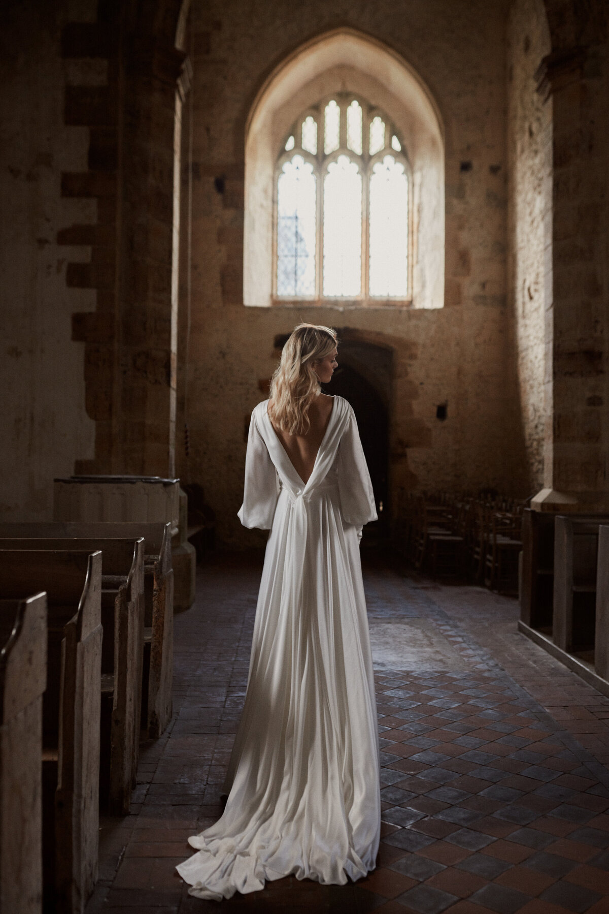 Long, silk wedding dress with deep v back on natural bride by british wedding dress designer, Luna Bea