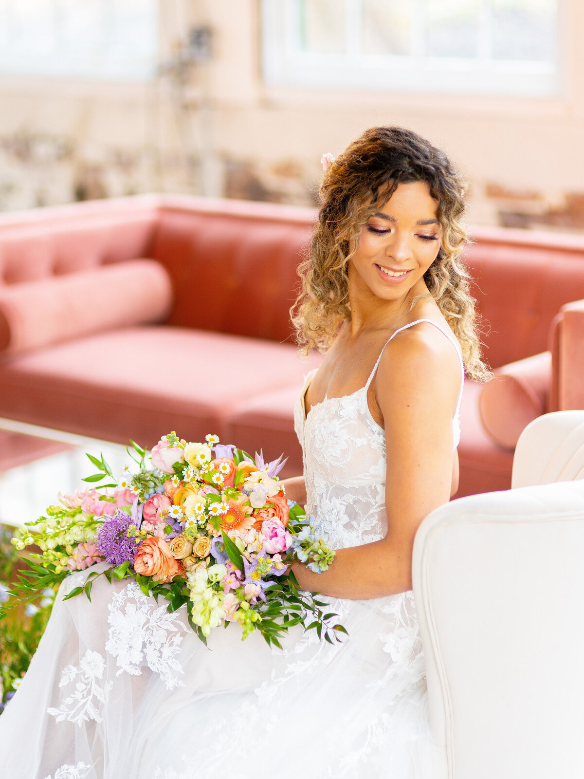 Bride looking over her shoulder while holding wedding bouquet
