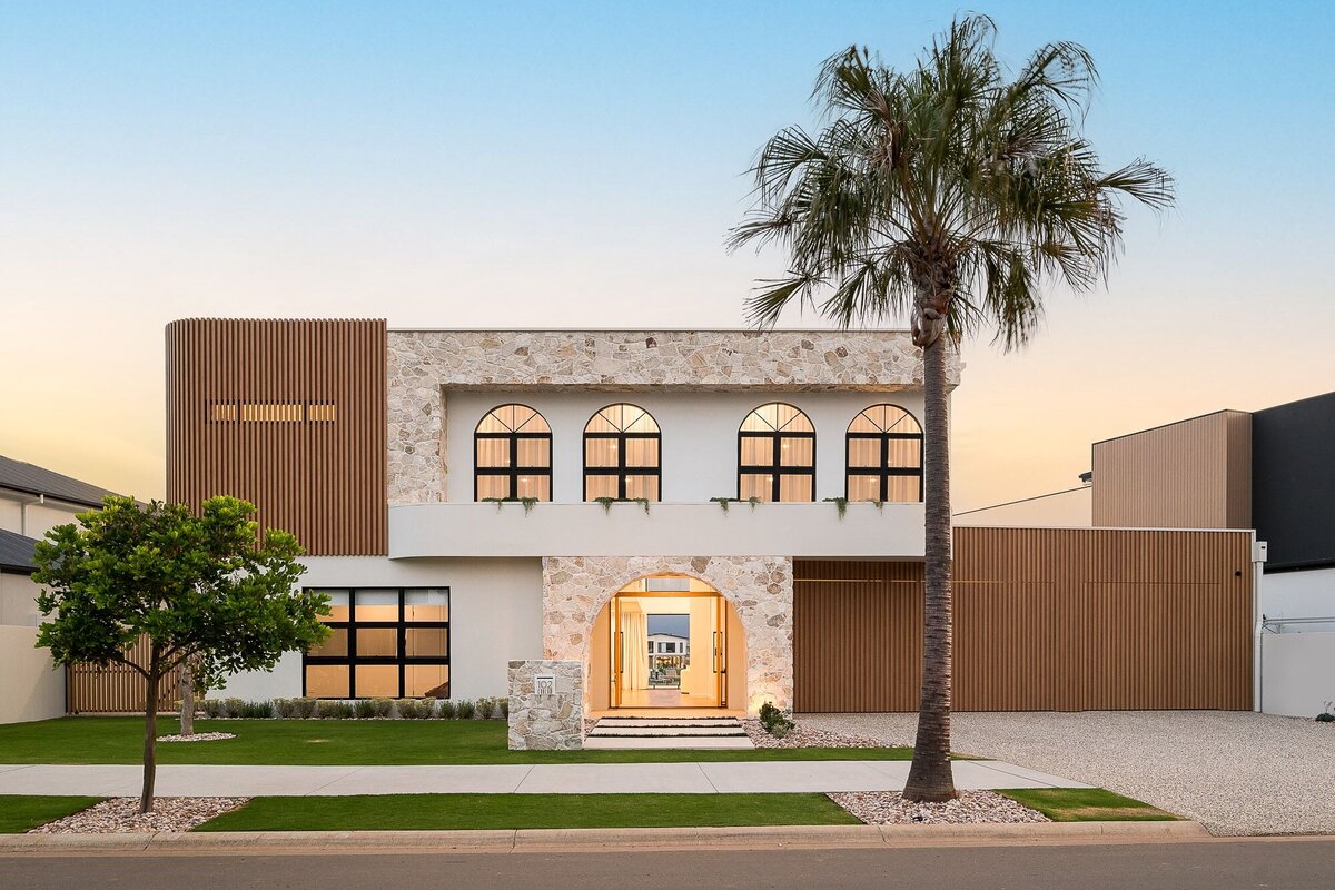 The Marisol project by NXTgen Construction, a modern Mediterranean home featuring warm neutral tones, arched windows, and elegant landscaping.