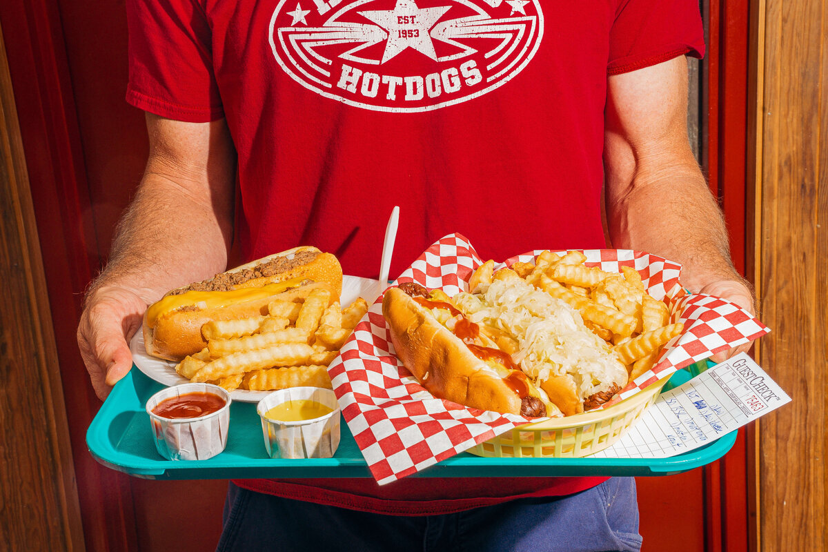 Food Photographer near me featuring man holding hotdogs in Spartanburg, South Carolina