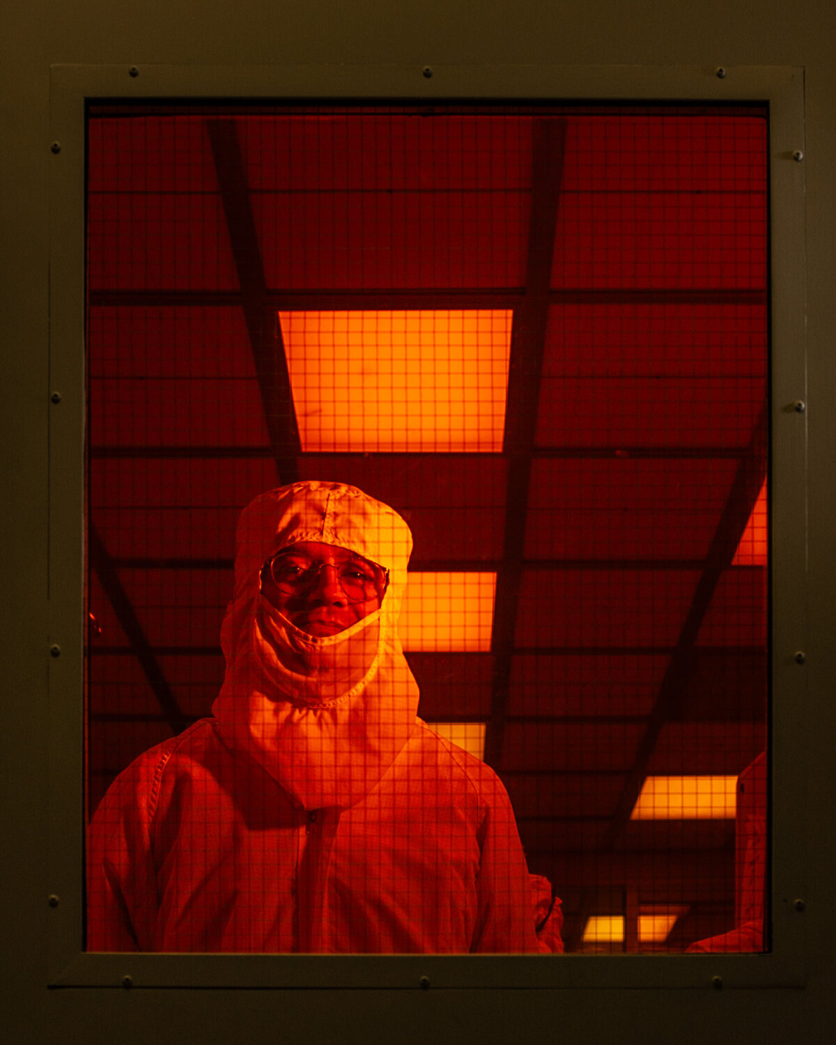 A person in a protective suit smiling