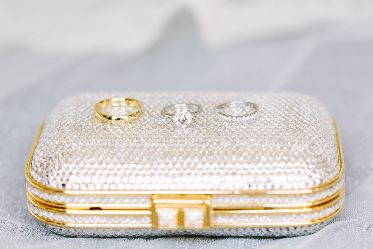 Sparkly clutch with wedding rings on top