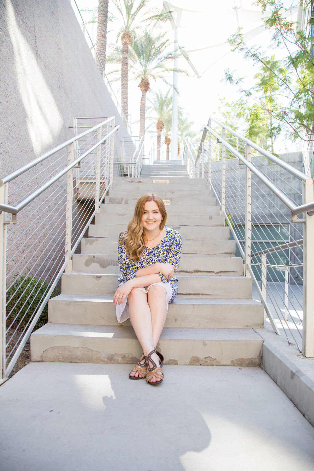 red headed young woman sitting on concrete stairs