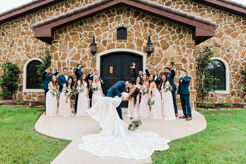 bride and groom with wedding party outside Austin Tx wedding venue
