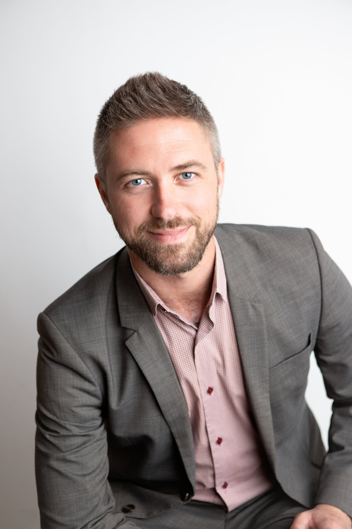 Studio headshot with plain white background
