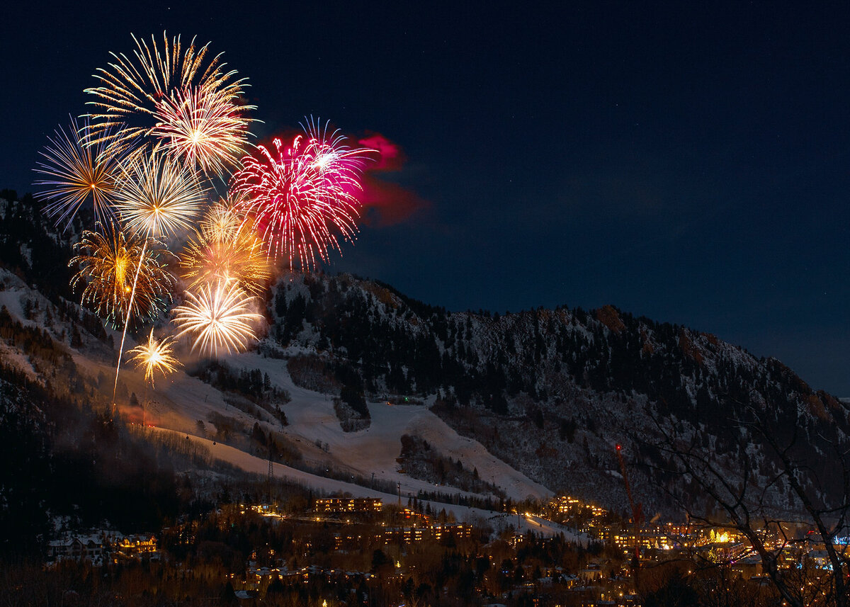 A fireworks display over a ski resort in France at a luxury party celebration.