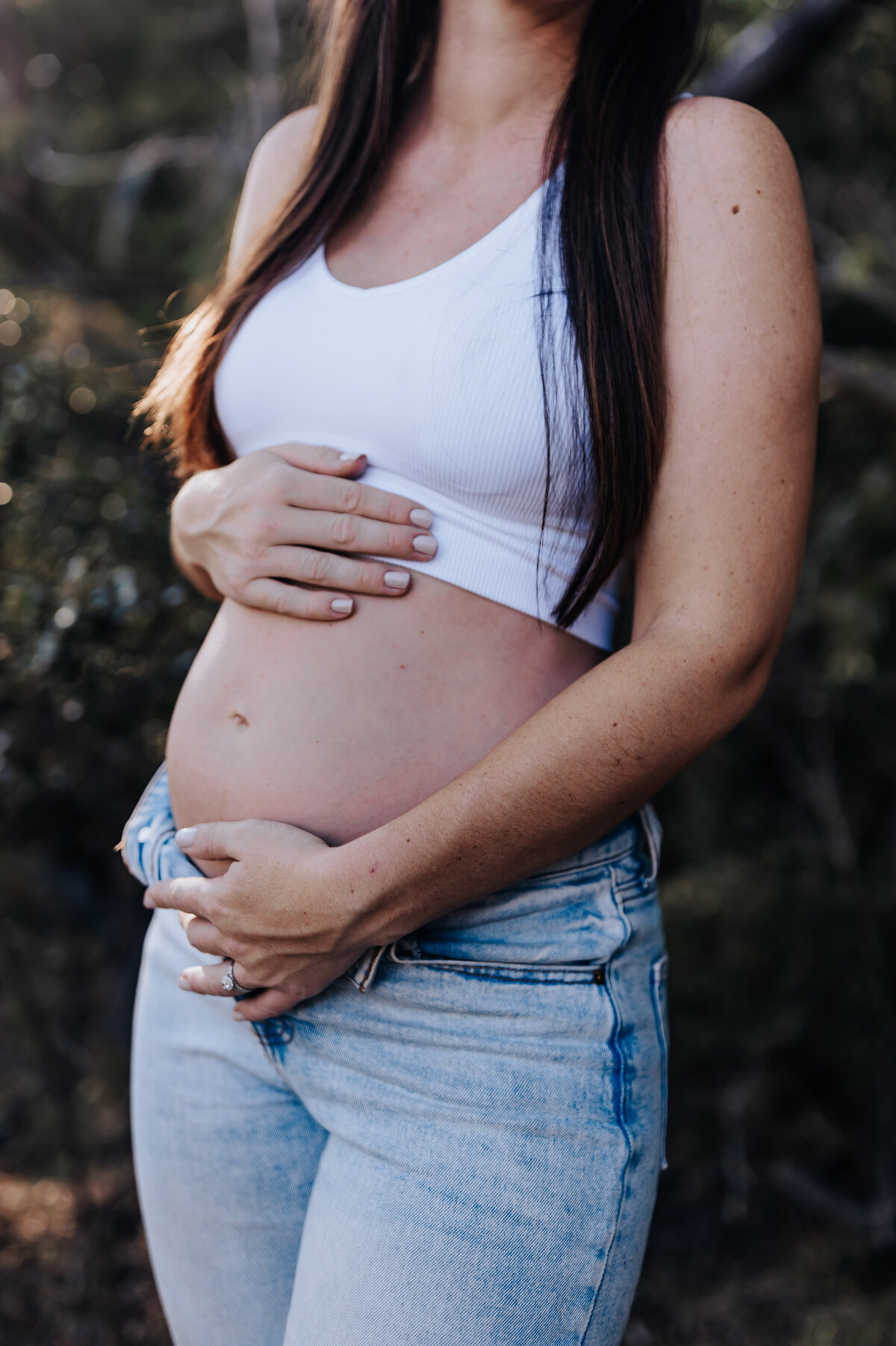 Nashville newborn photographer captures mother holding baby belly