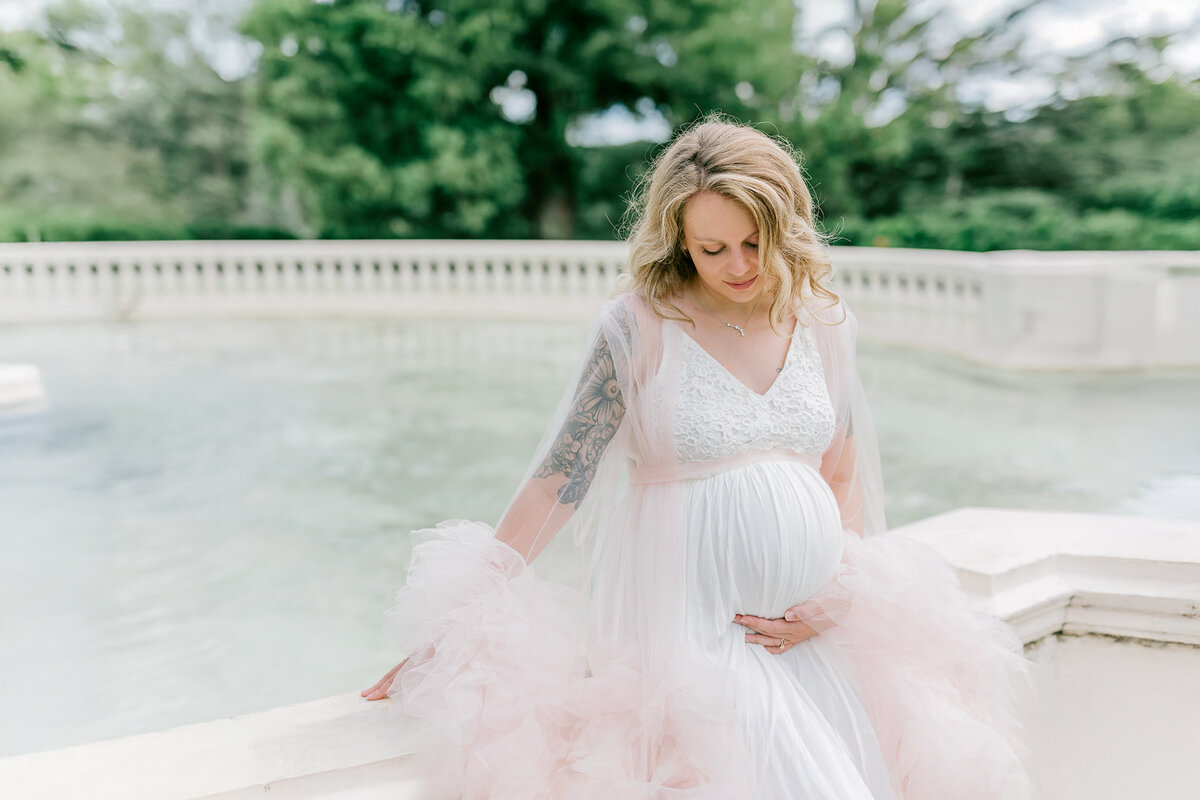 Pregnant mama smiles at her bump during her Maymont maternity photo session in Richmond.