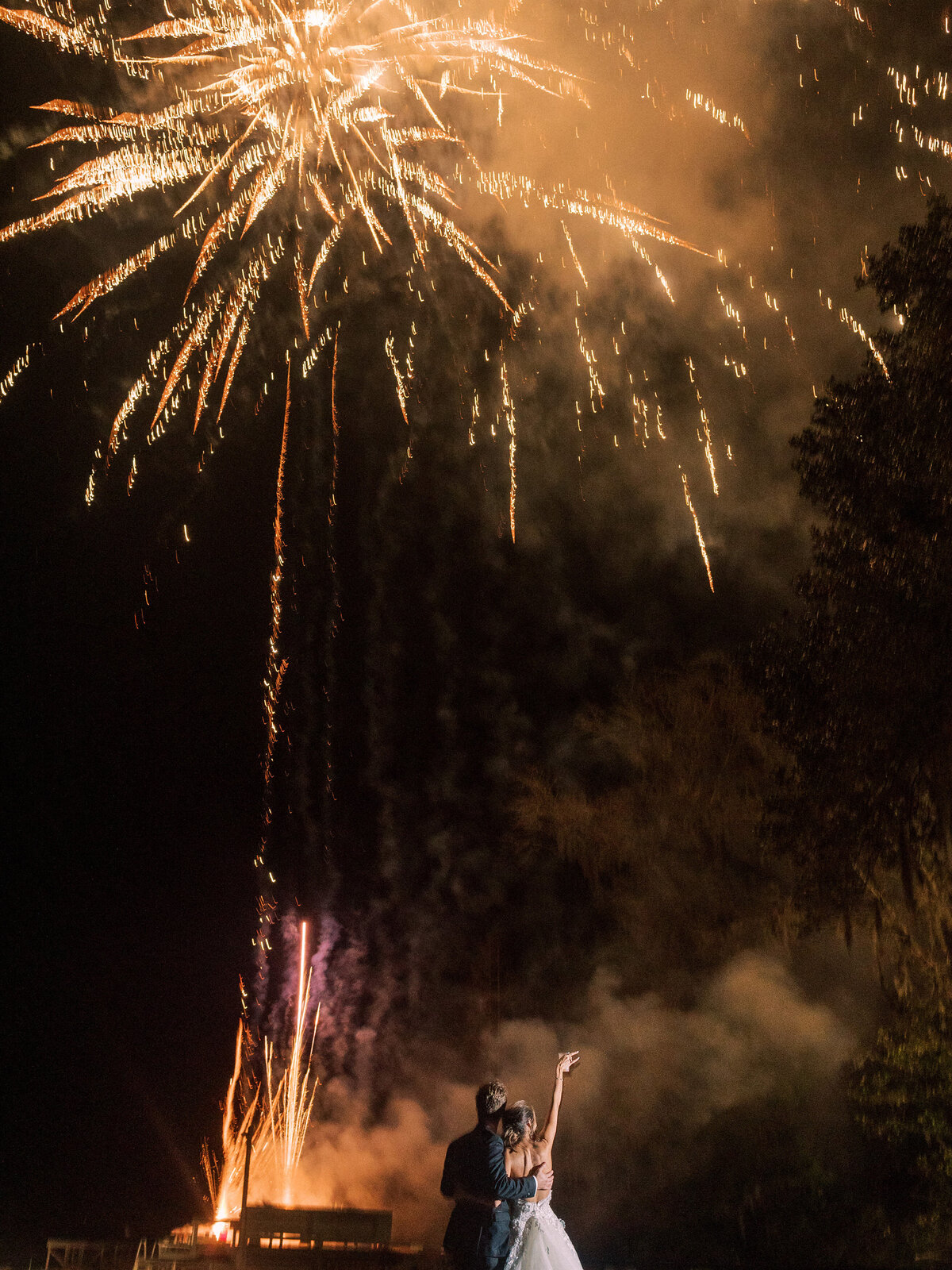 Bride and groom celebrate under fireworks