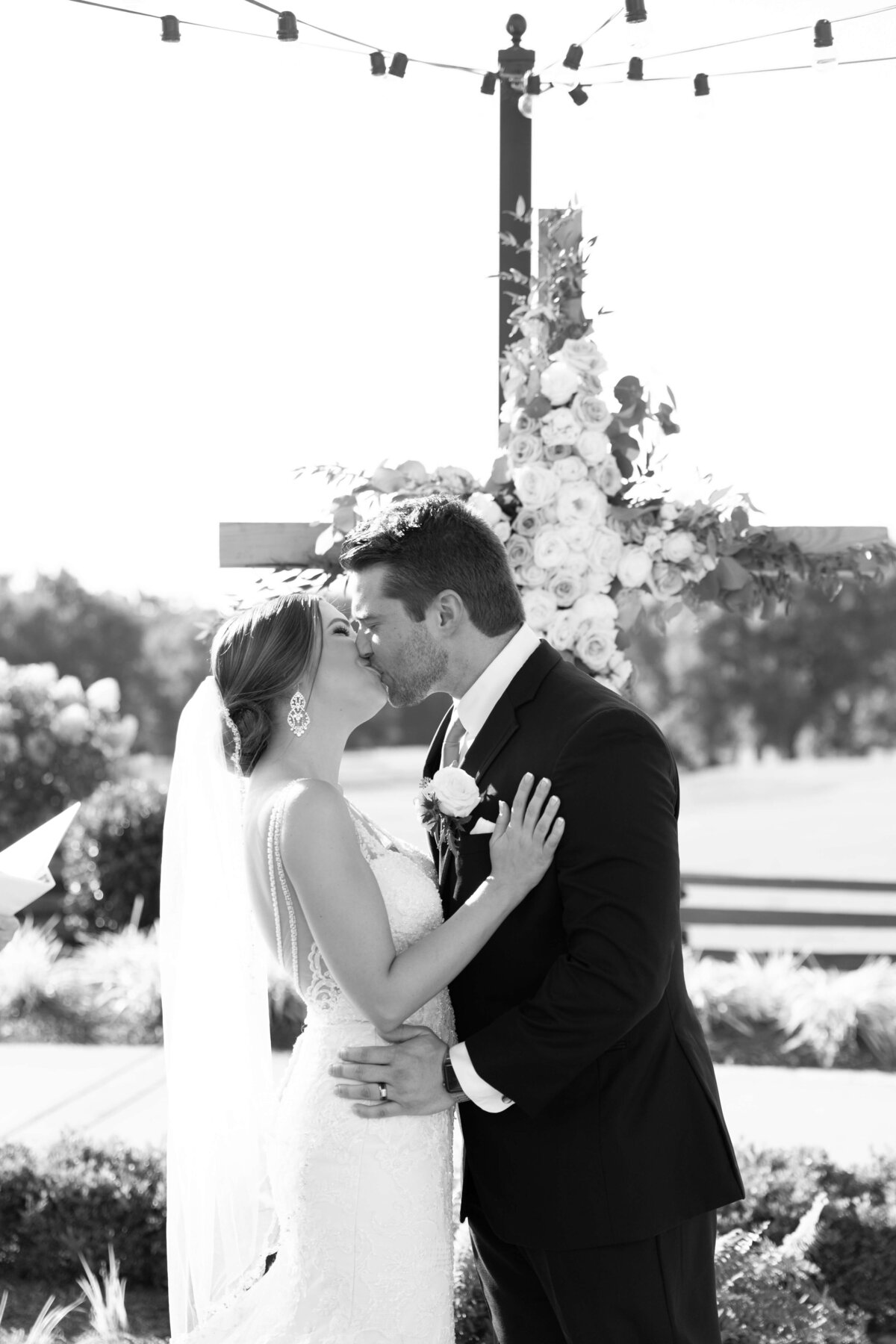 Bride and groom first kiss at wedding ceremony at Stones River Country Club