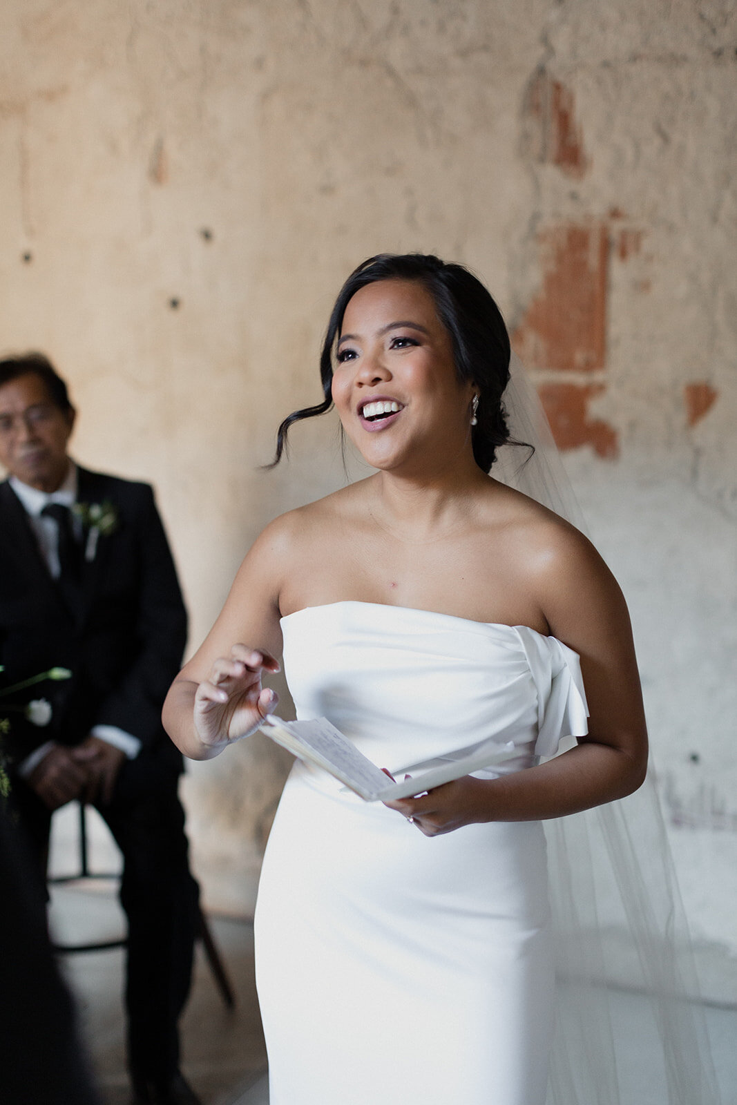 bride smiling sharing her vows