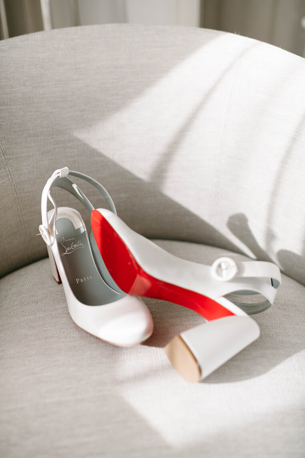 Elegant bridal shoes with floral embellishments displayed at St. Regis Aspen, set against a soft, romantic backdrop.