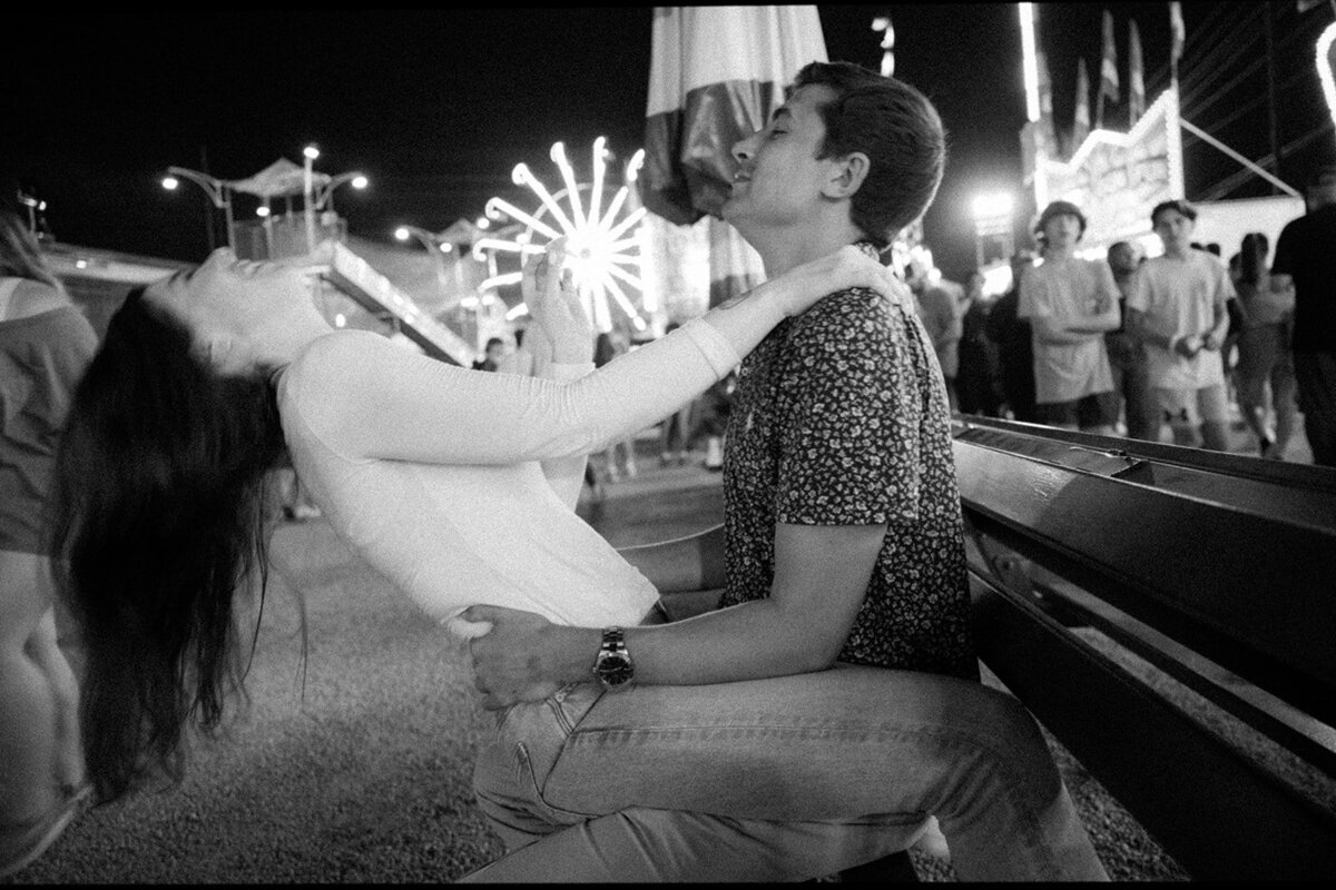 Couple laughs together under the night light in black and white photo shot at the Williamson County Fair in Franklin, TN.