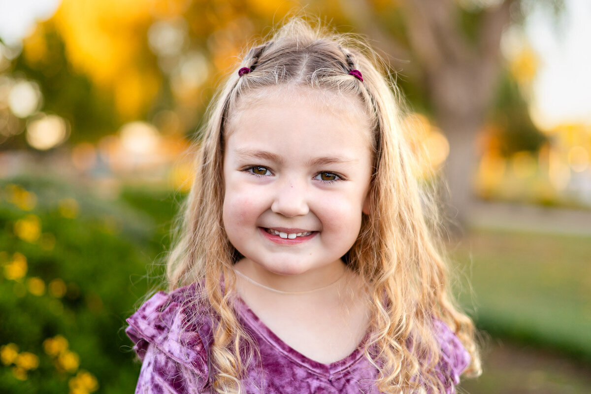 Preschool girl smiling in natural light at a San Francisco Bay Area park during lifestyle school photography – Ellobelle Photography