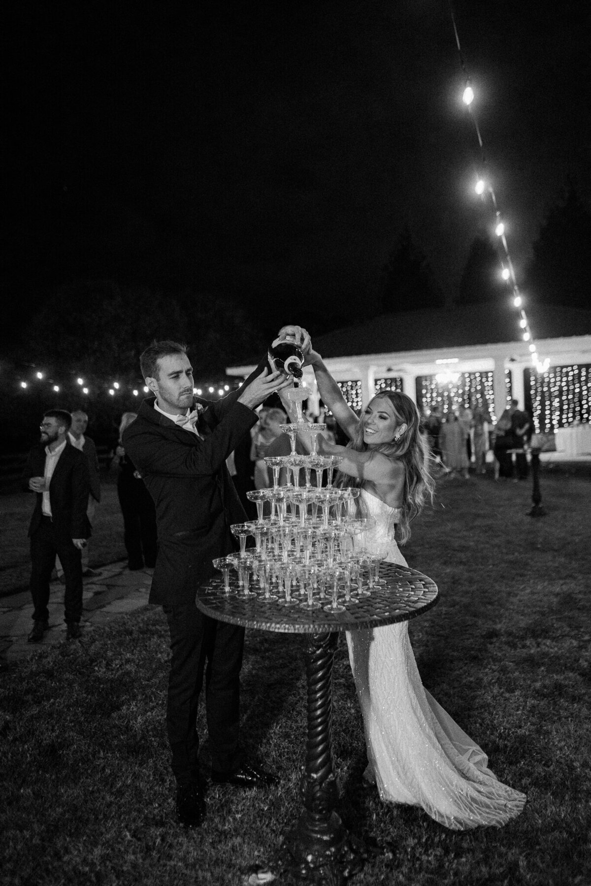 Wedding couple pouring champagne