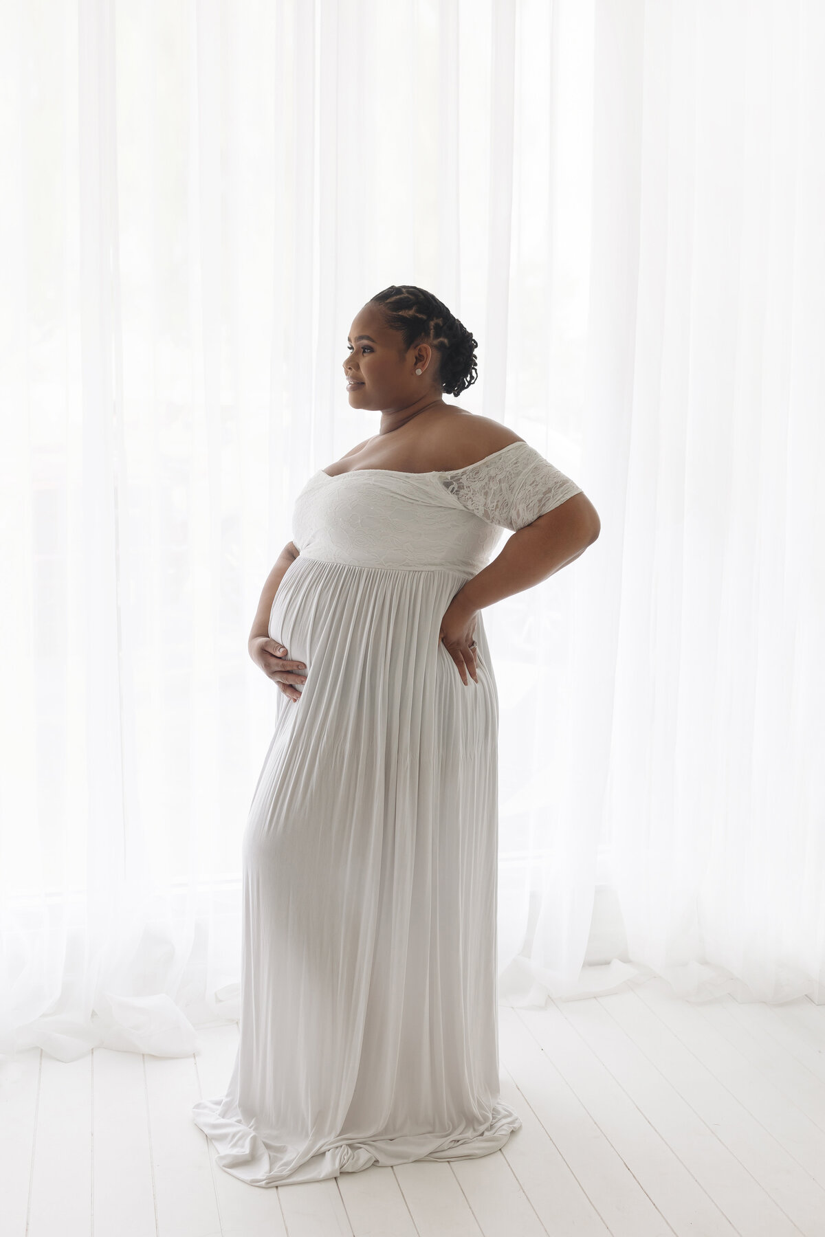 woman with one hand on belly the other on back