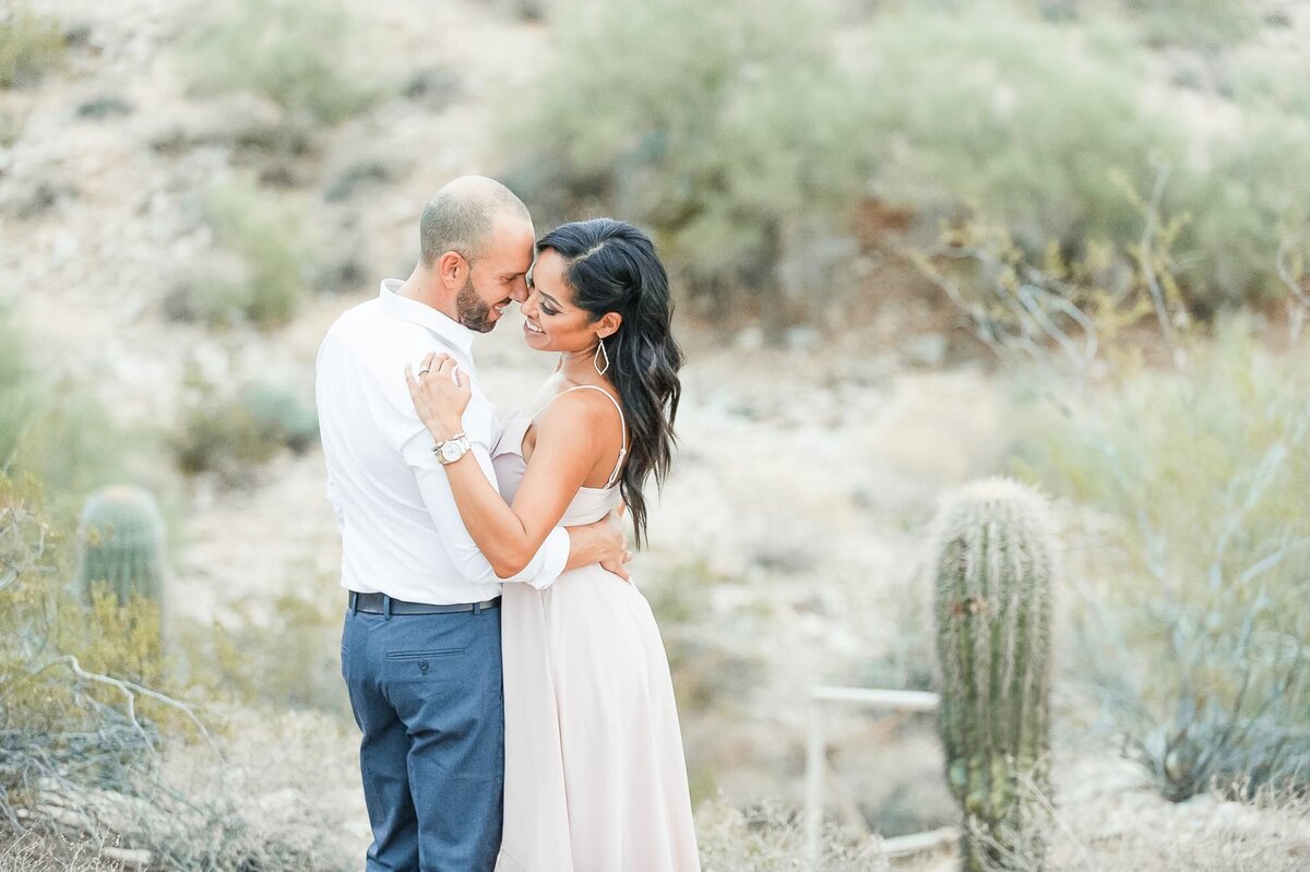 engaged-couple-standing-by-cacti