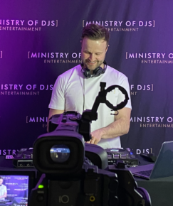 DJ livestreams Olympic-themed set with camera setup and Ministry of DJs backdrop in frame