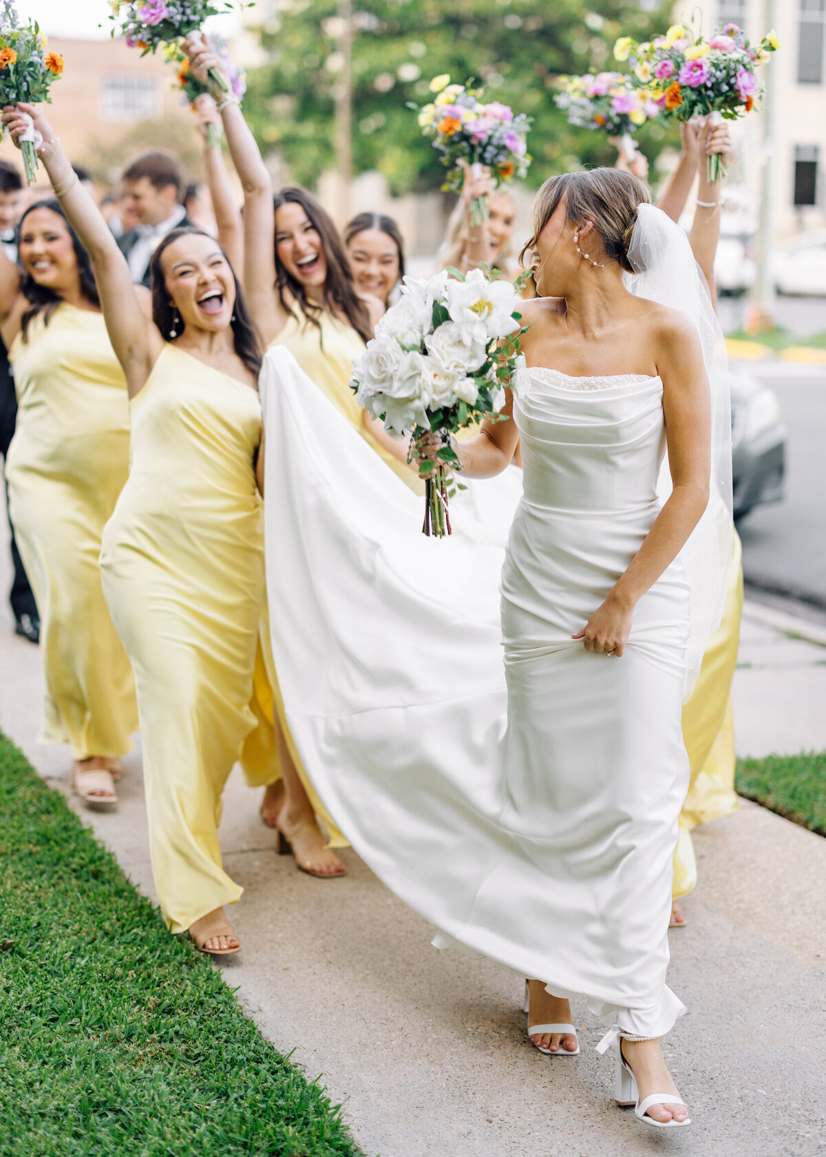 A heartfelt, candid moment between the bride and her bridesmaid after the wedding, filled with joy and laughter, beautifully captured on film by Morgan Alysse, Louisiana film photographer.