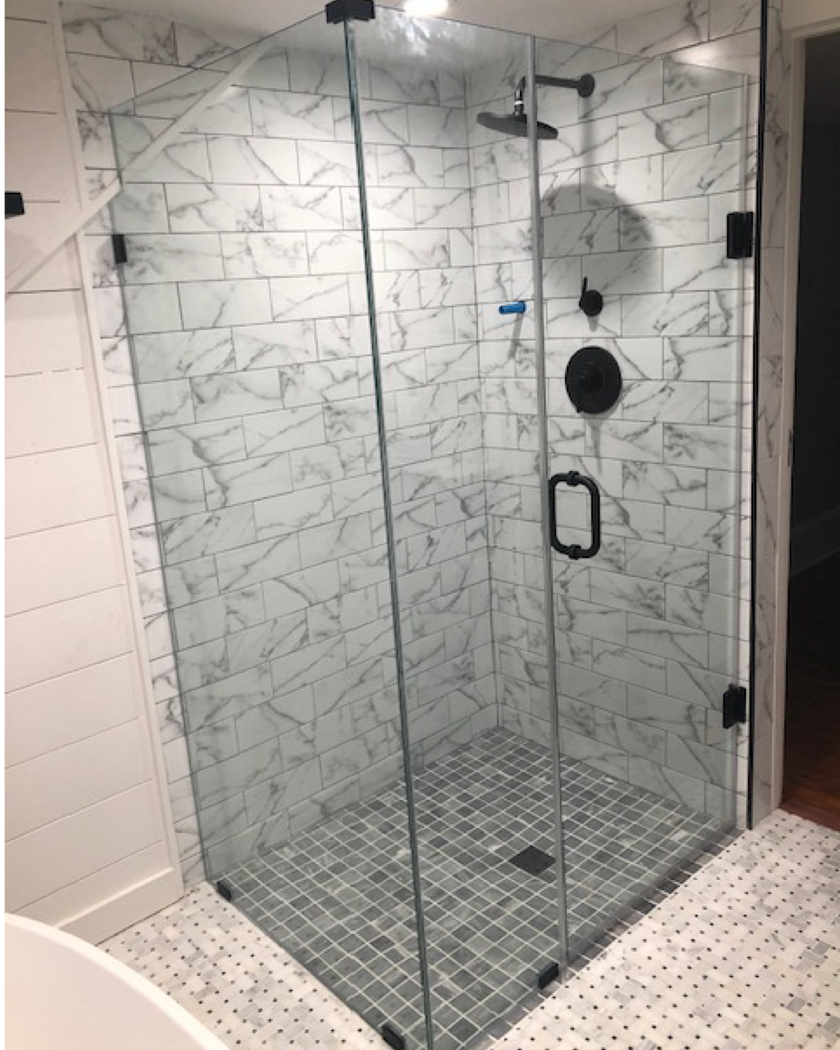 Clean Glass shower white subway tile. black finishes 