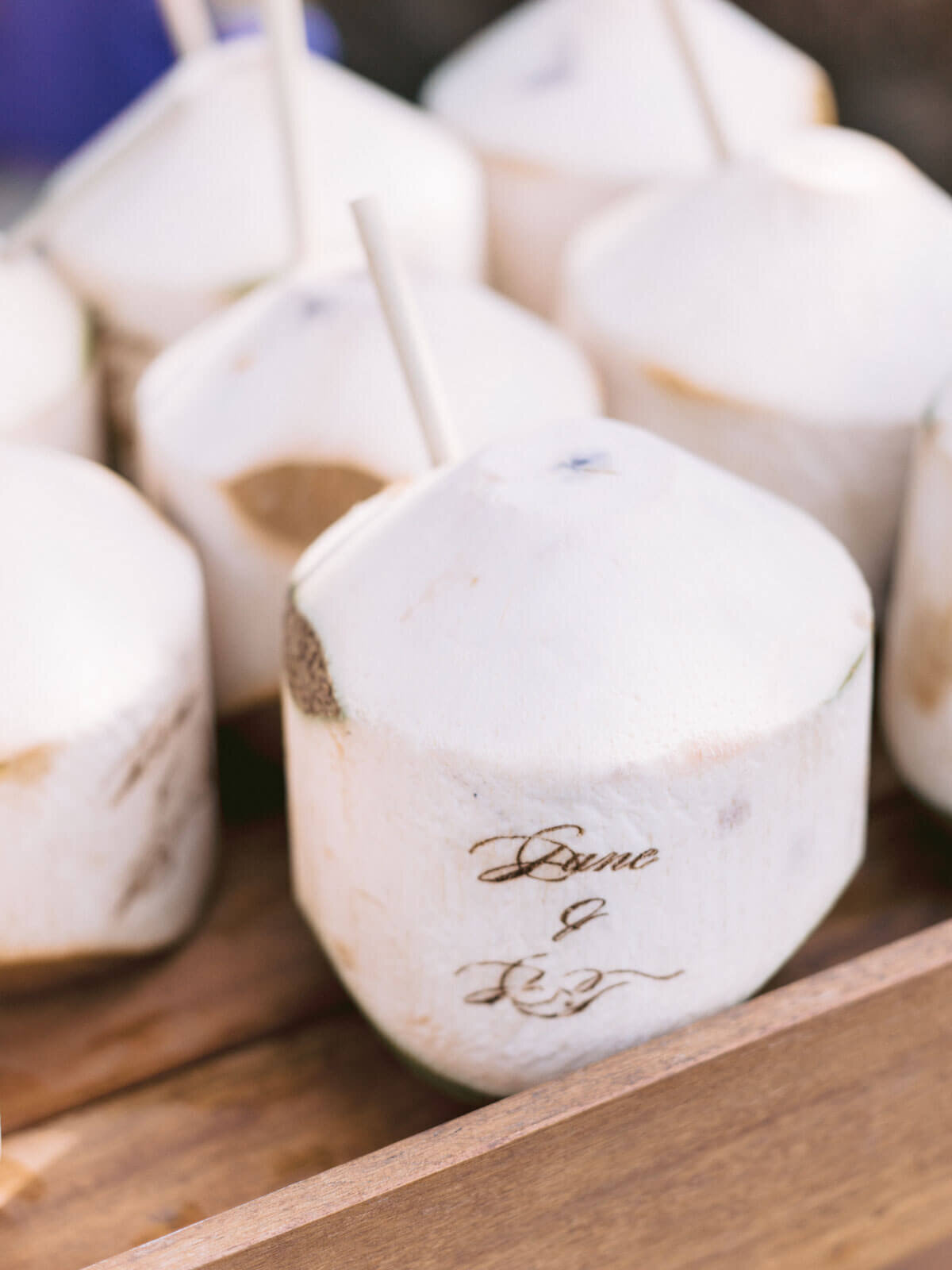 Coconuts ready to drink with a straw, are engraved with the bride and groom's names in Khayangan Estate, Bali, Indonesia.