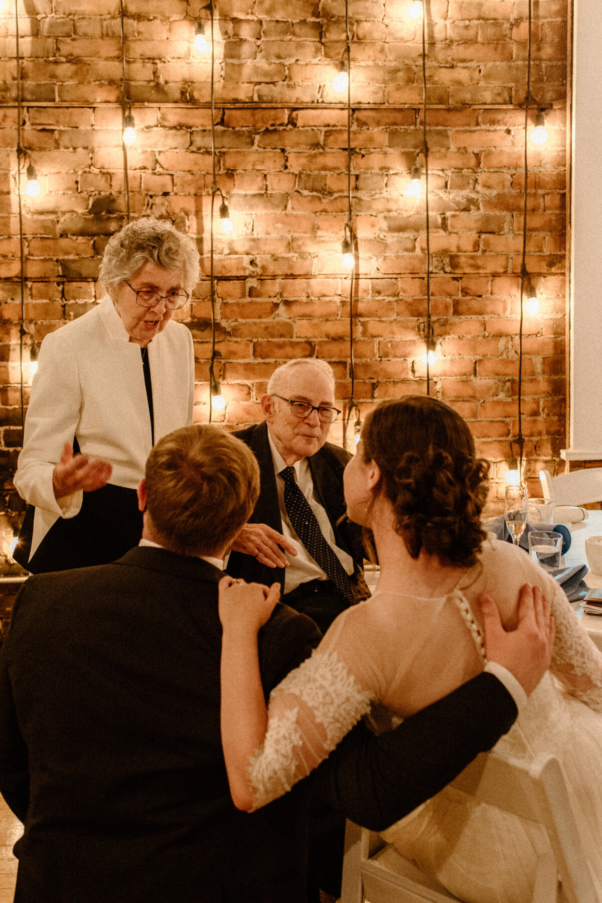 hamilton ontario spice factory wedding bride and groom listen to advice from grandparents