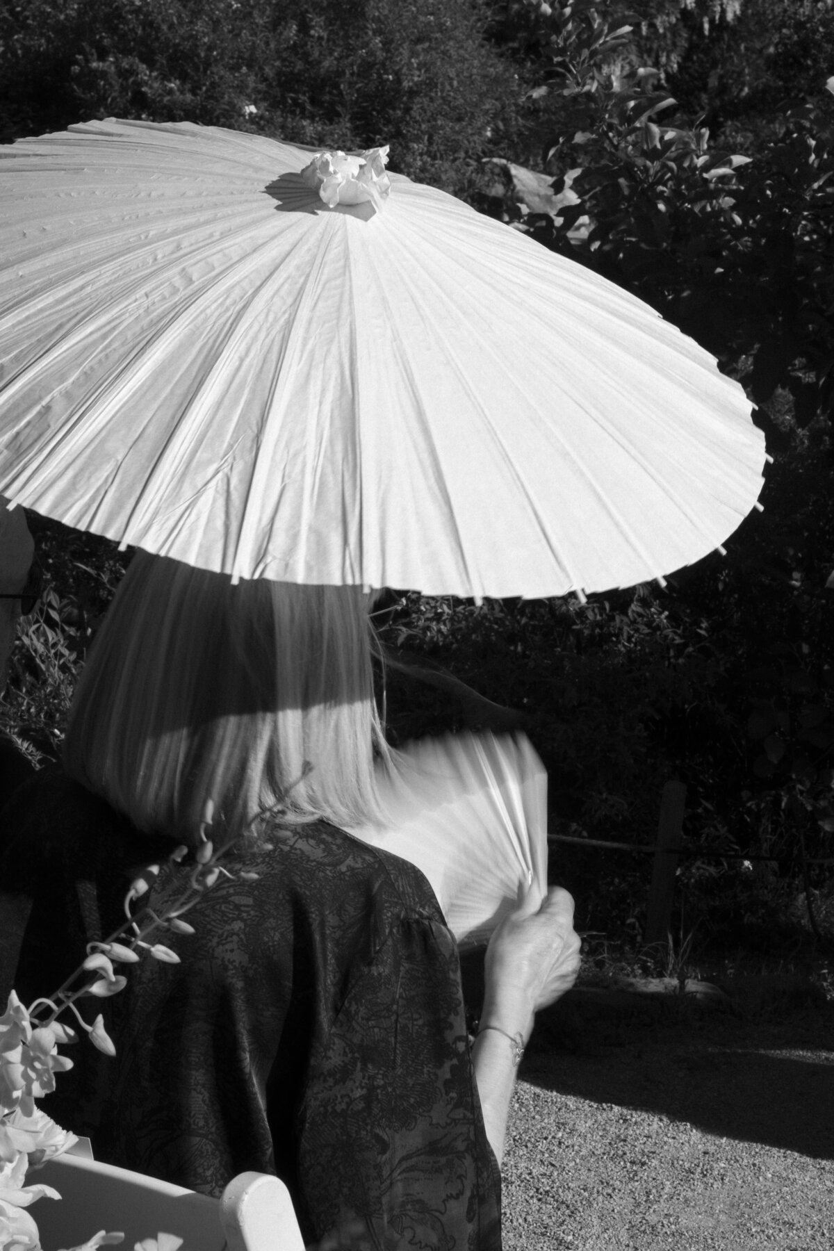wedding ceremony in sun with umbrellas