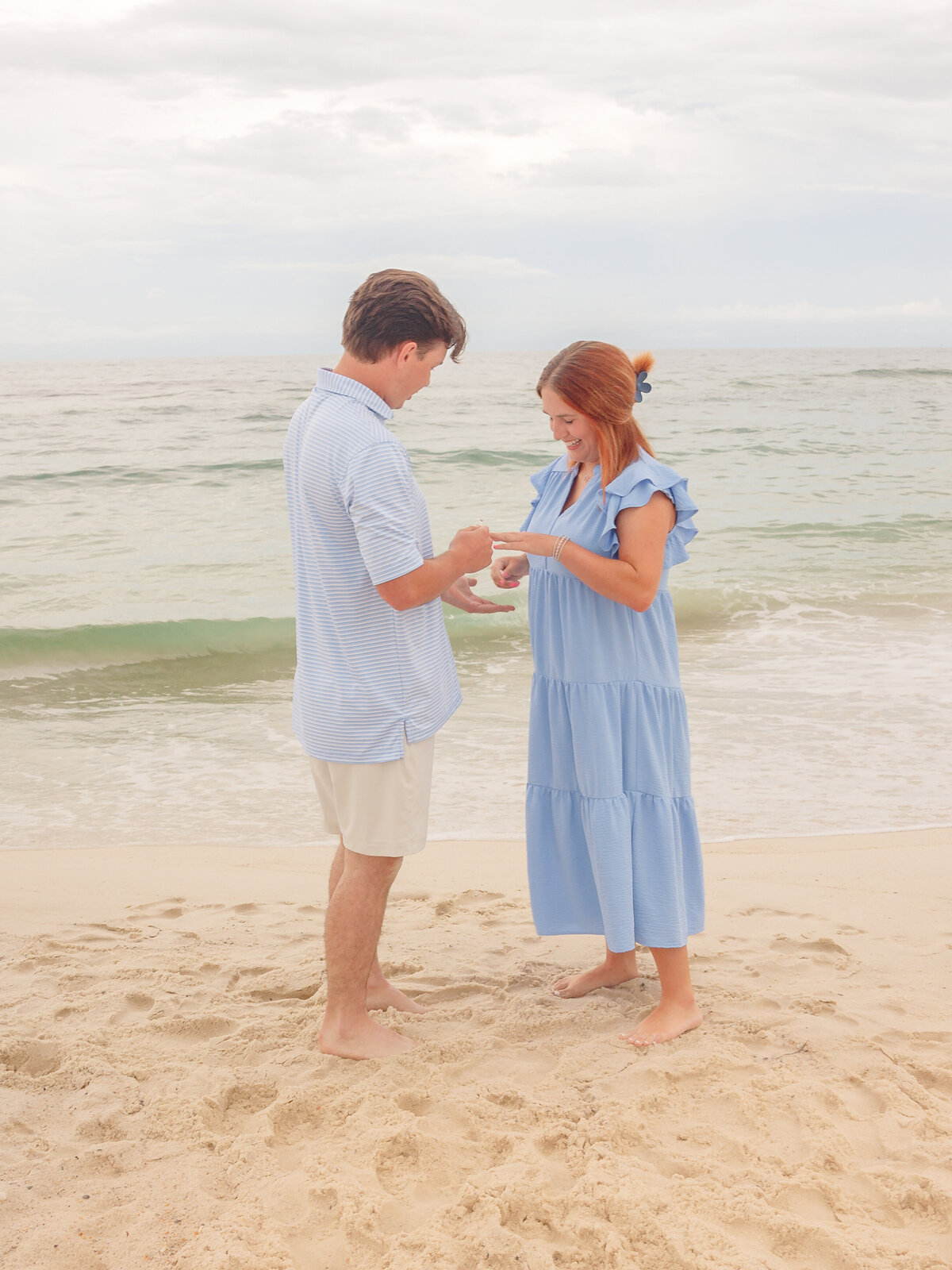 Sweet moment of groom to be placing the ring on his fiancee's finger