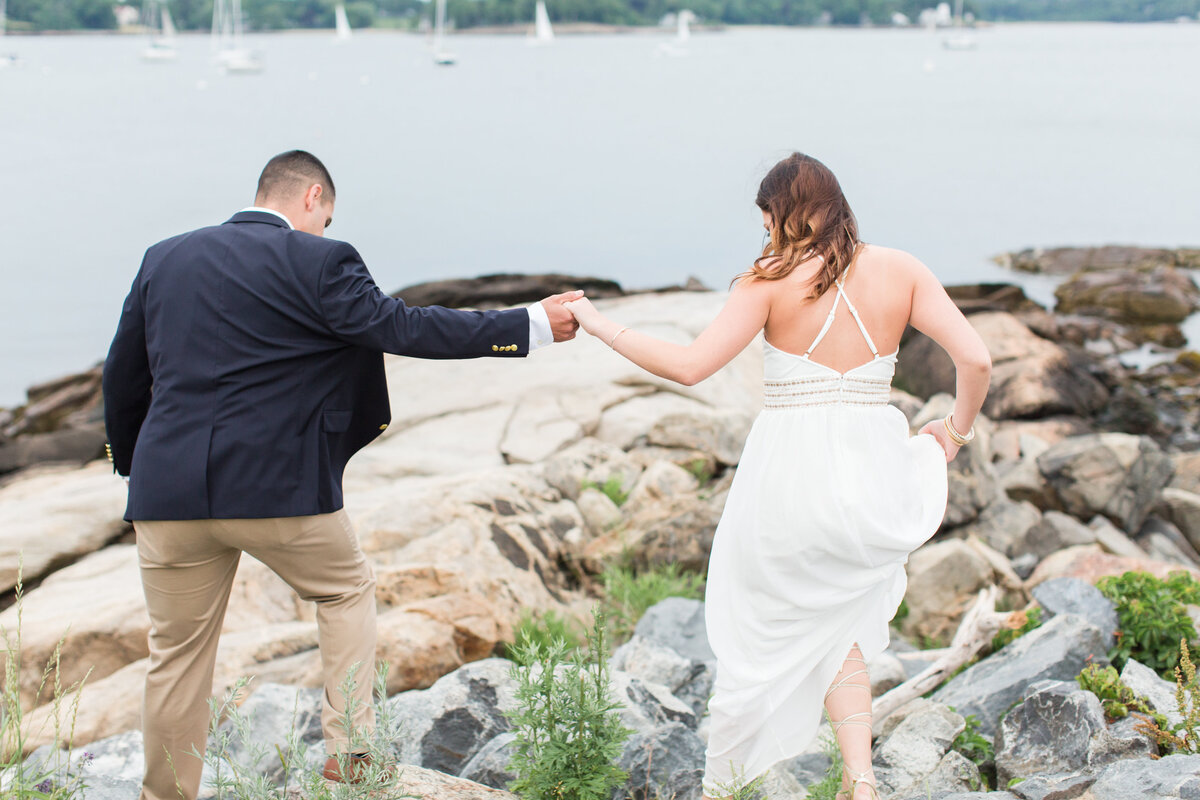 Couple walking on rocks near beach