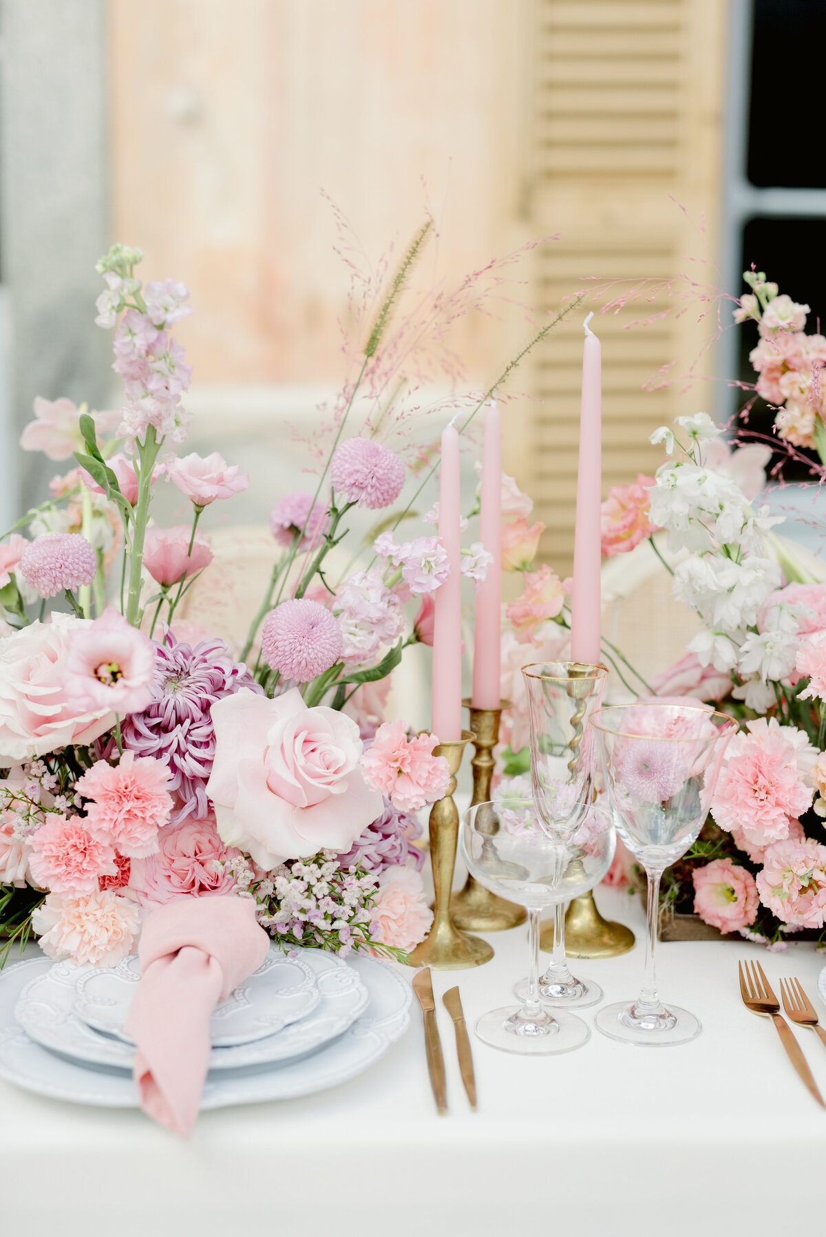 Pink table wedding florals, taper candles wedding