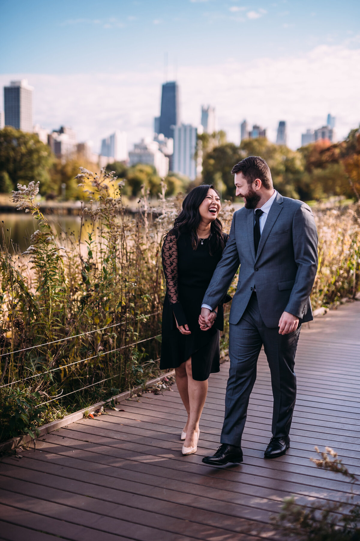Couple in formal clothes walking through Chicago for engagement photos