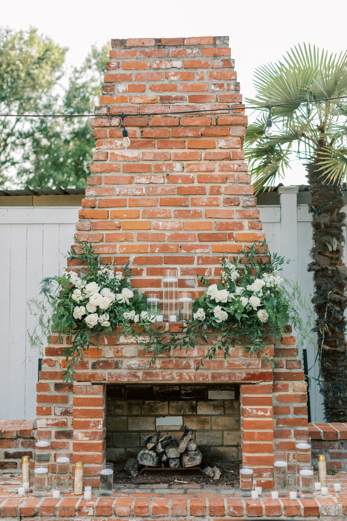 White and green florals decorate the brick fireplace.