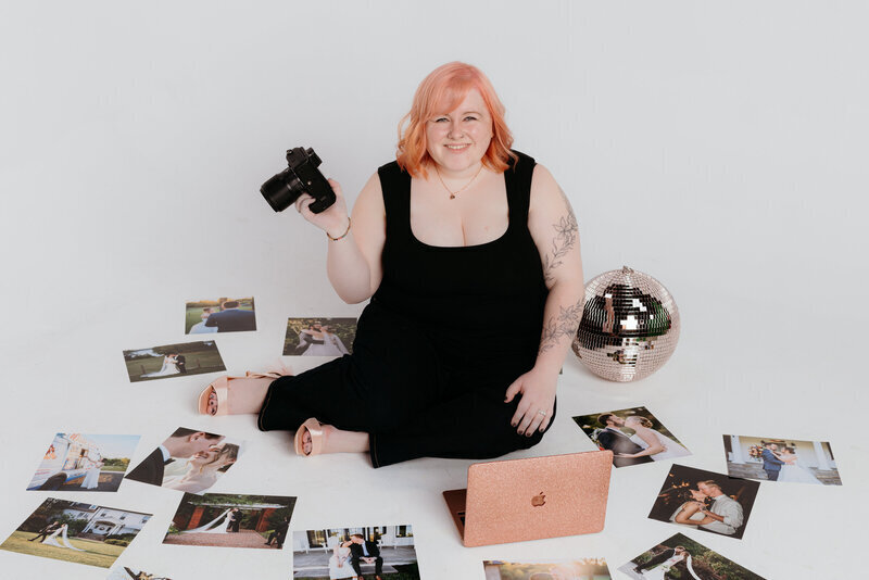 Melissa Cook, Northern VA Wedding Photographer, poses with her camera