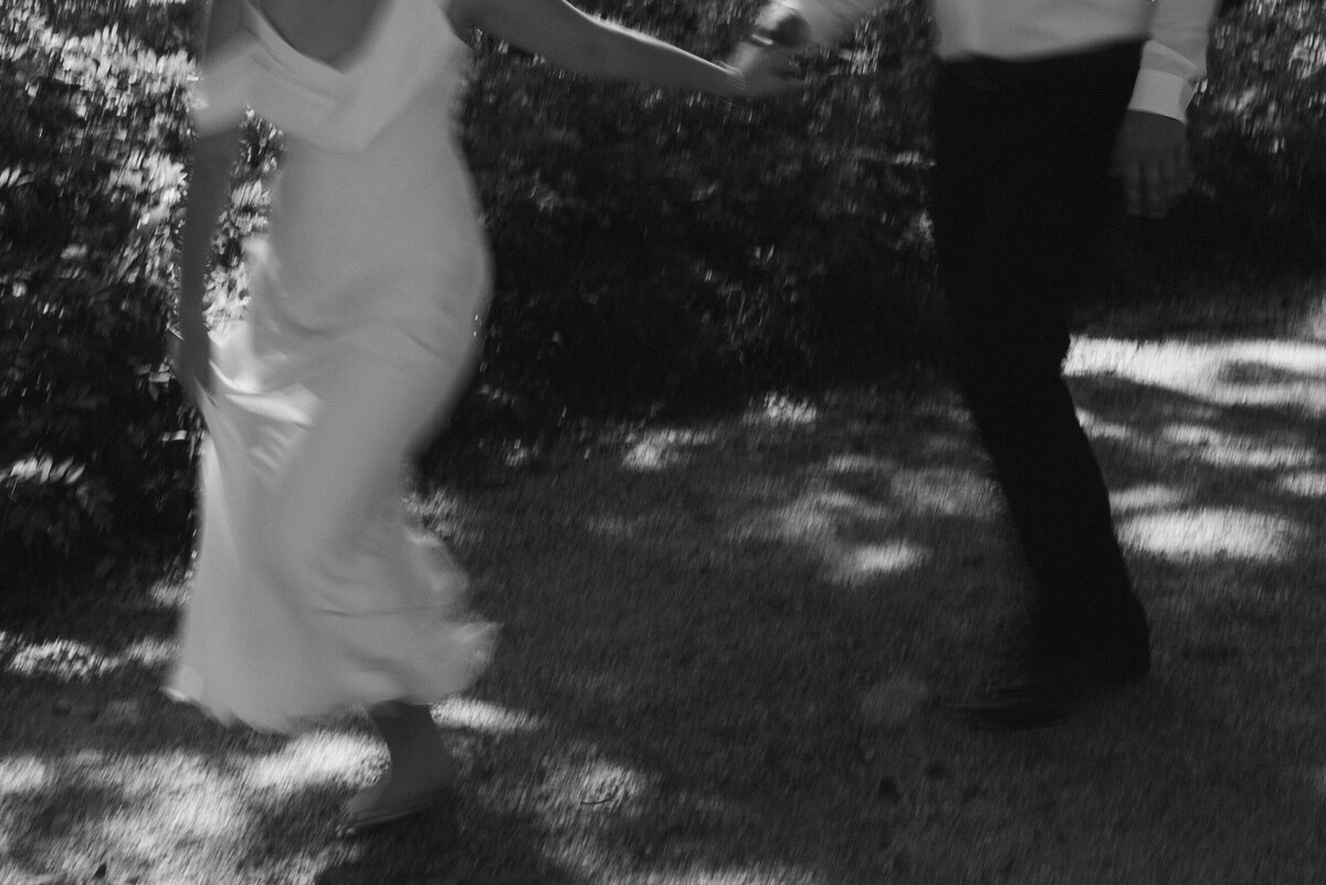a black and white motion blur photo of a couple running. 