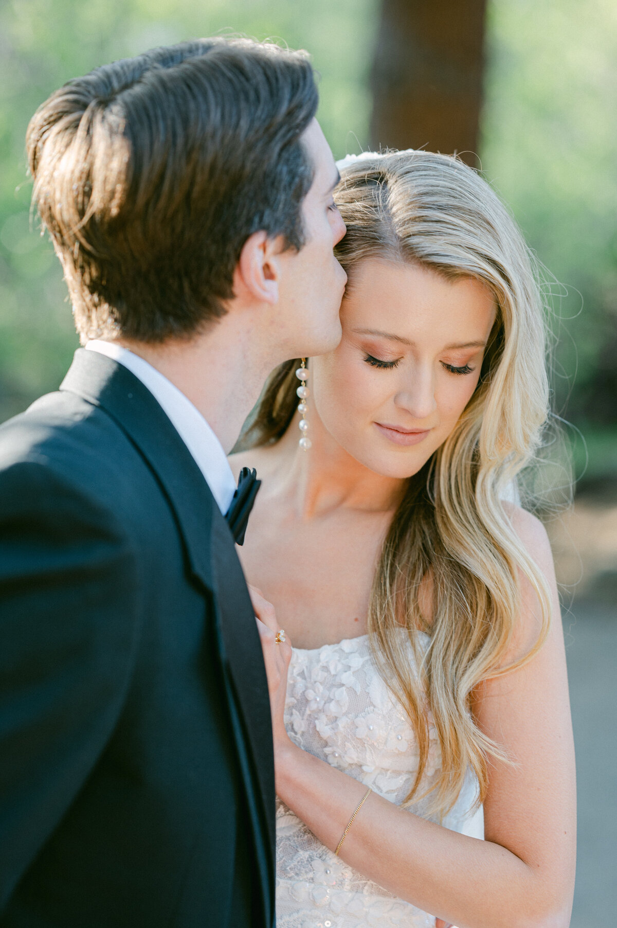 Groom kissing his Bride during their wedding reception
