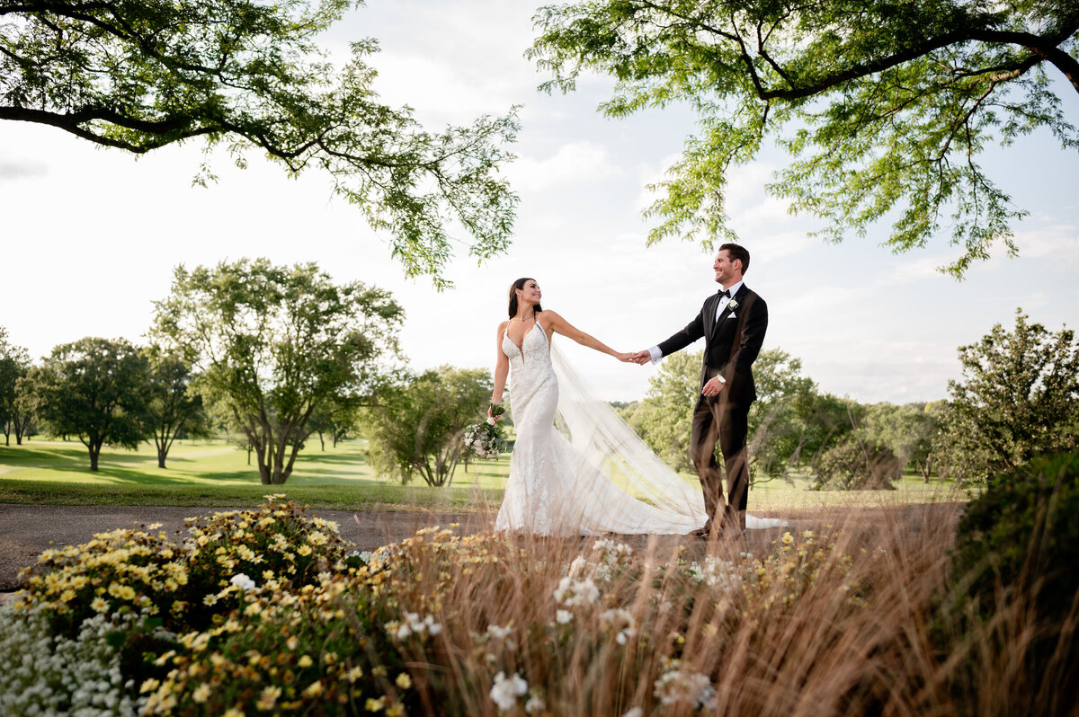 Bride walks with groom on the golf course at Biltmore country club in Barrington, Illinois