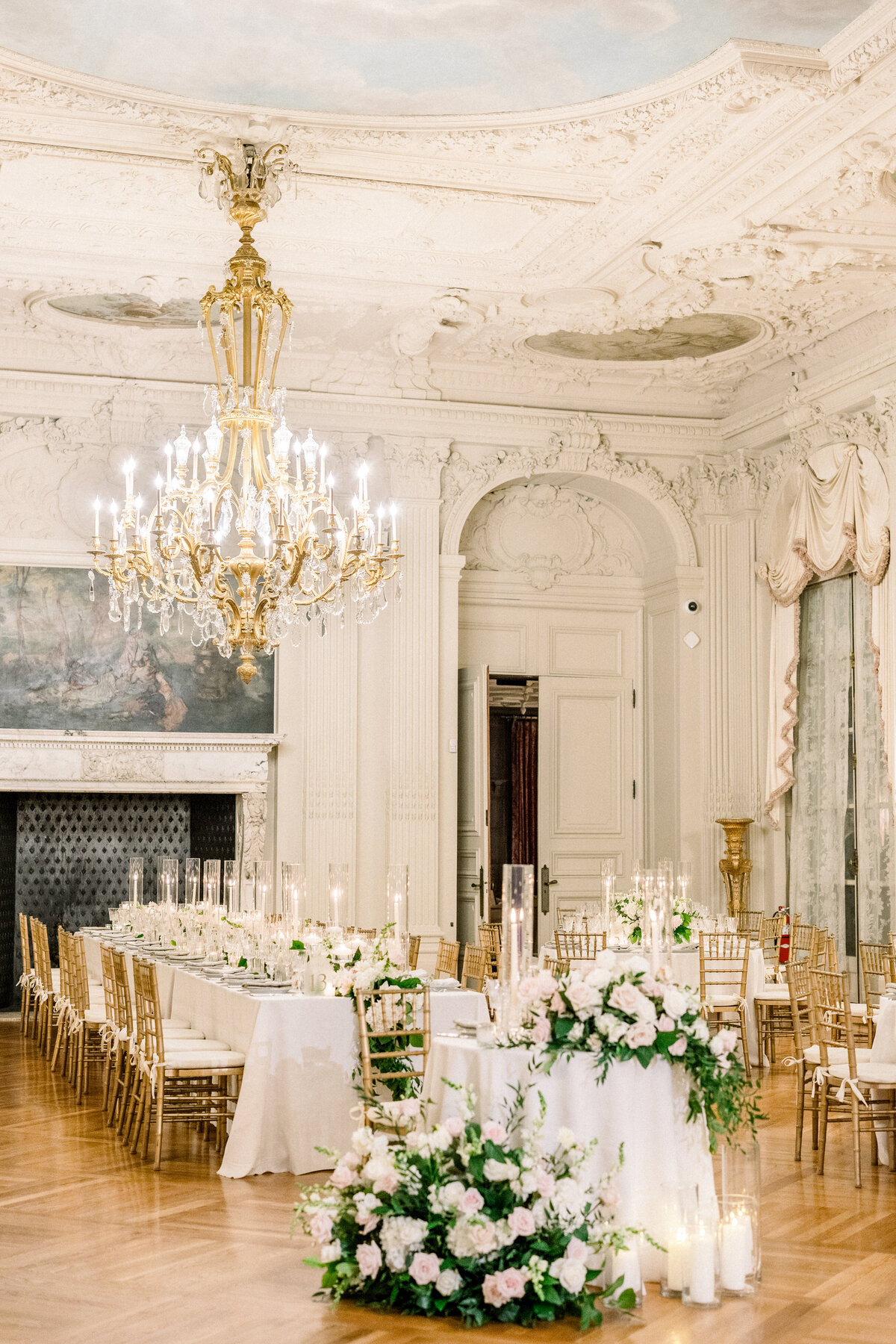 candle lit round sweetheart tablescape  in ballroom of rosecliff mansion in newport rhode island